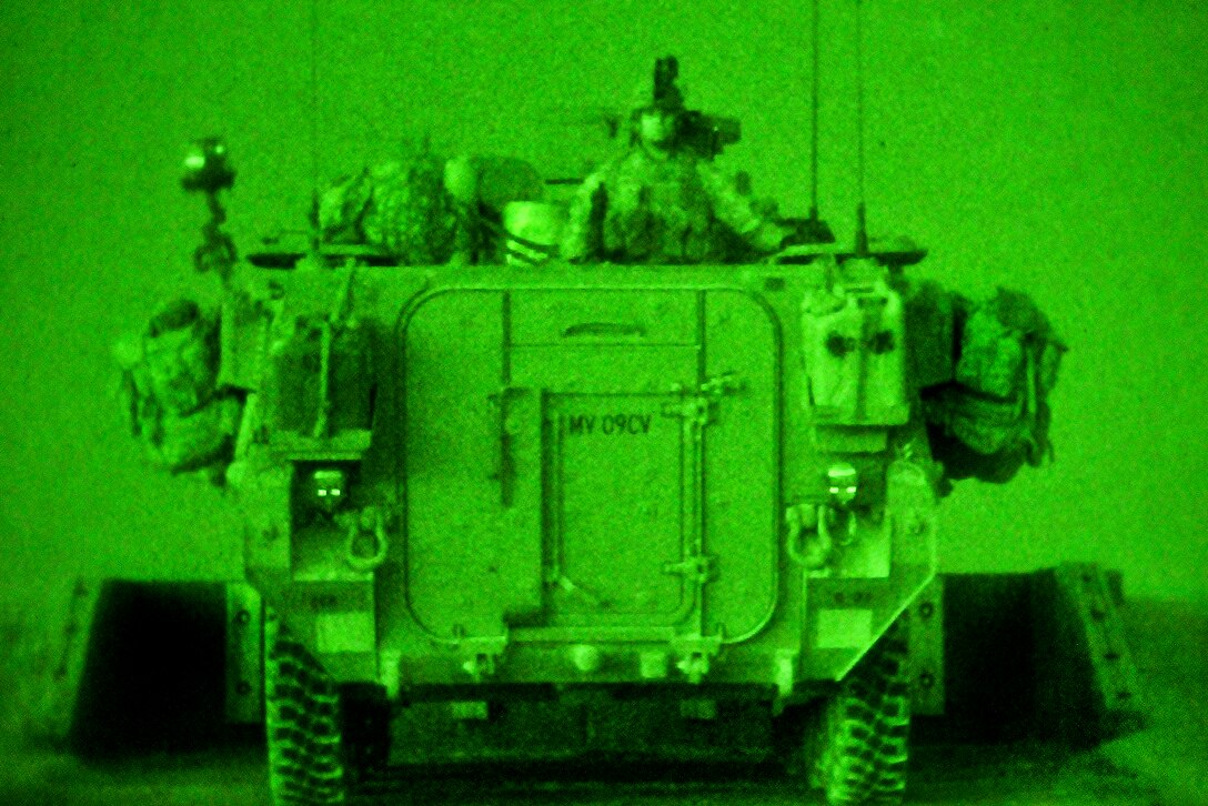 As seen through a night-vision device, U.S. soldiers move their Stryker vehicle into firing position during a live fire exercise while evaluating their company at the Grafenwoehr Training Area in Germany, May 25, 2012.  

