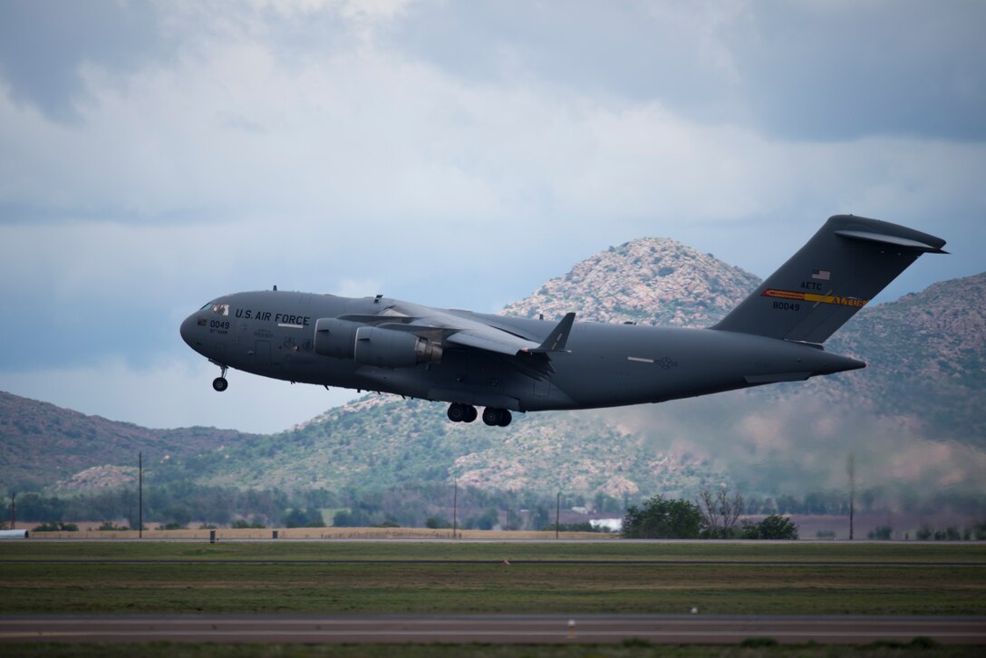 A U.S. Air Force C-17 Globemaster III cargo aircraft performs a touch and go at Altus Air Force Base, Okla., May 27, 2014. The 97th Air Mobility Wing is the Air Force's only C-17 and the KC-135 Stratotanker refueling aircraft training wing. (U.S. Air Force photo by Staff Sgt. Nathanael Callon/Released)
