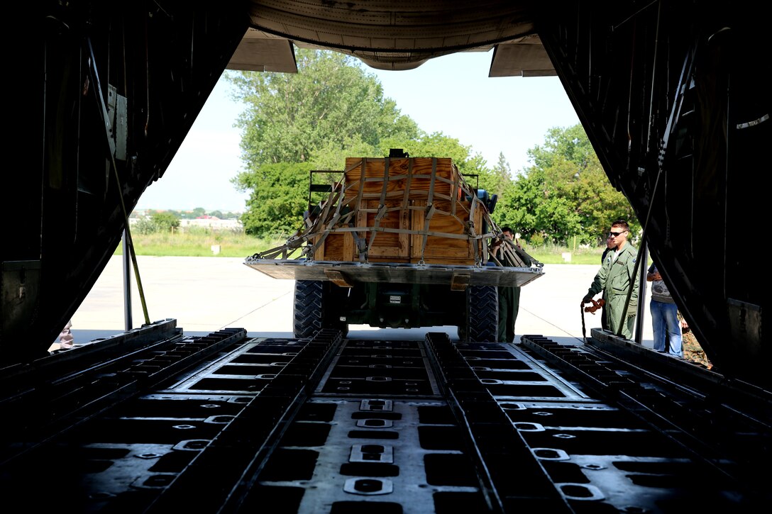 U.S. Marine Cpl. Brandon Glavin, a parachute rigger with Black Sea Rotational Force 14, from 3rd Battalion, 8th Marine Regiment, uses a forklift to raise a pallet onto an aircraft during a pallet building military-to-military engagement on Mihail Kogalniceanu Air Base, May 28, 2014. The Marines and Romanians worked together, exchanging pallet building techniques, different equipment and aircraft loading procedures during the military to military engagement in order to learn effective tactics from each other and increase interoperability between the two nations’ embarking units. 