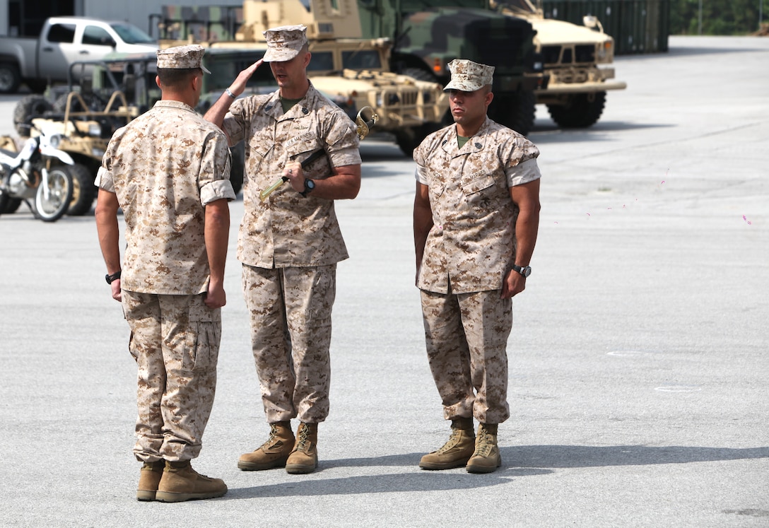 Sgt. Maj. Tracy A. Linch, outgoing sergeant major of 2nd Marine Special Operations Battalion renders a salute to Lt. Col. Benjamin J. Pappas, commanding officer, 2nd MSOB, prior to relinquishing his post and transferring the noncommissioned officer’s sword to Sgt. Maj. Edwin A. Mota, incoming sergeant major, 2nd MSOB, during a Relief and Appointment Ceremony at the 2nd MSOB headquarters, May 29.