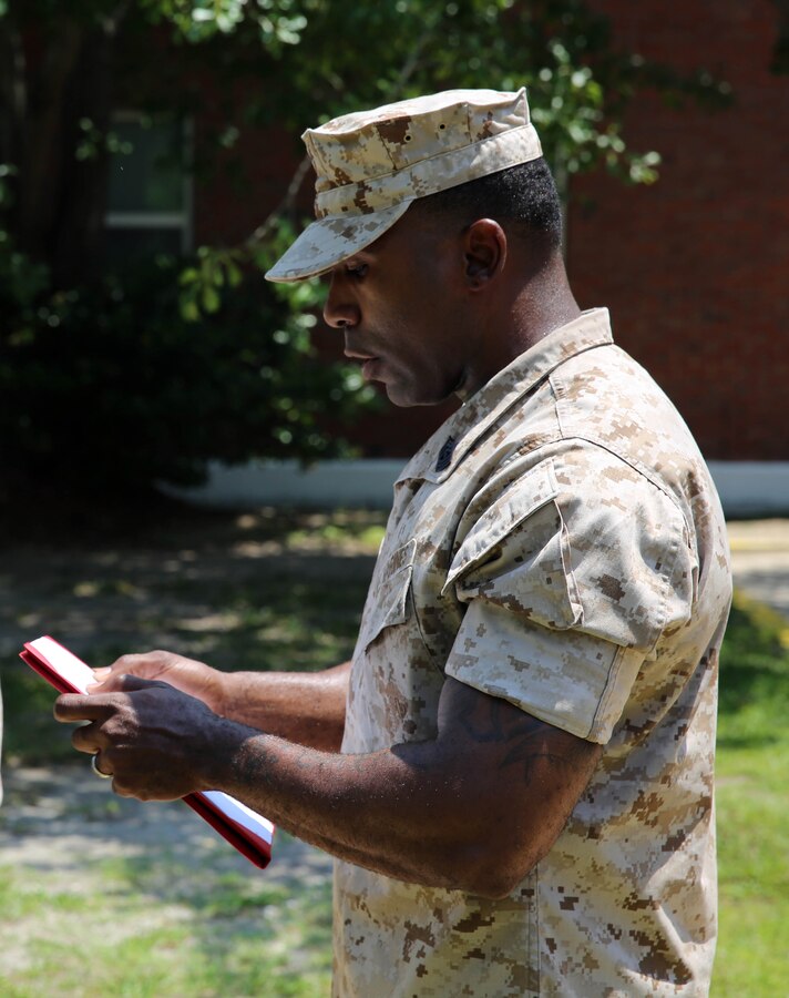 First Sgt. Juarice Collins, company first sergeant of Fox Company, 2nd Battalion, 2nd Marine Regiment, 2nd Marine Division, reads the citation for 1st Lt. Grant Todd’s Bronze Star Medal with combat distinguishing device during a ceremony held at the battalion headquarters aboard Marine Corps Base Camp Lejeune, N.C., May 28, 2014. The Bronze Star Medal is awarded for acts of heroism, acts of merit or meritorious service in a combat zone. Acts of heroism are rewarded with a combat distinguishing device.