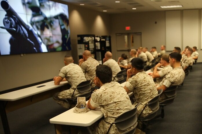 Marines with Combat Logistics Battalion 6, Combat Logistics Regiment 2, 2nd Marine Logistics Group watch a video during their brief at the Marine Security Guard school in Quantico, Va., May 14, 2014. The Marines toured the school as a way to expand their understanding of the broad range of mission carried out by the Marine Corps.