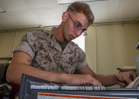 Pfc. Jeffrey D. Wann, a supply clerk assigned to the 26th Marine Expeditionary Unit, organizes a records cabinet at the MEU command post during the work day at Camp Lejeune, N.C., May 19, 2014. Wann, a Lancaster, Penn., native, is one of the newest additions to the 26th MEU team. (U.S. Marine Corps photo by Lance Cpl. Joshua W. Brown/Released)