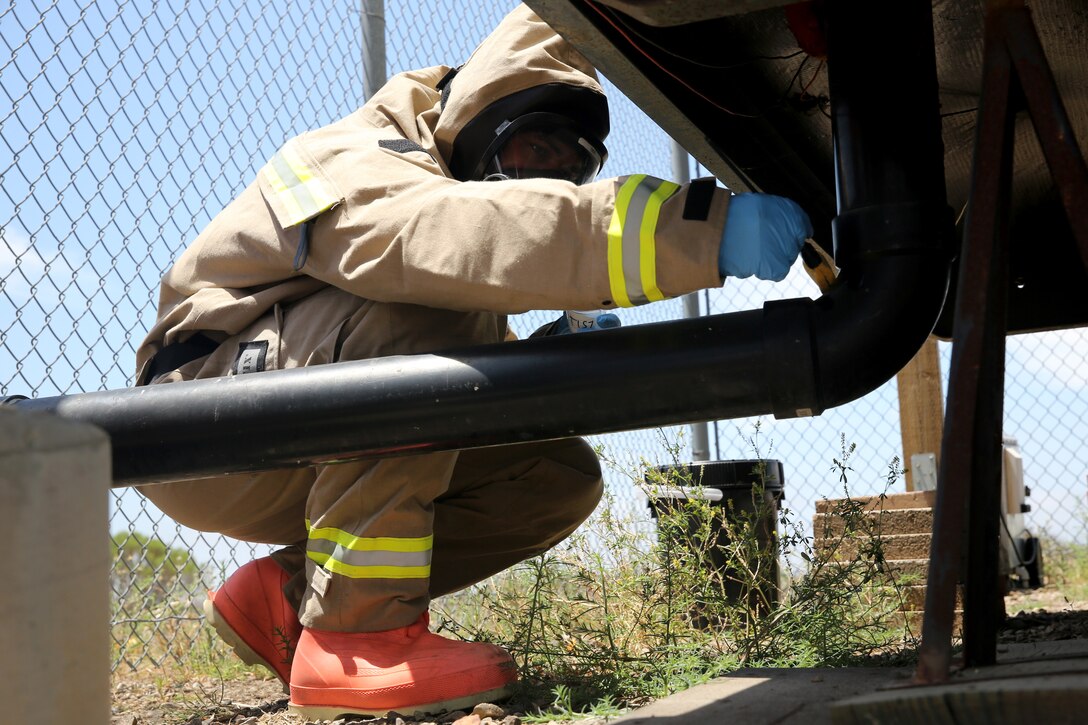 Pfc. Aaron Allen, an Aircraft Rescue and Firefighting specialist with Headquarters and Headquarters Squadron collects a swab sample during a training exercise aboard Marine Corps Air Station Miramar, Calif., May 29. The training was held to ensure the effectiveness of an interagency response to a biological incident. 