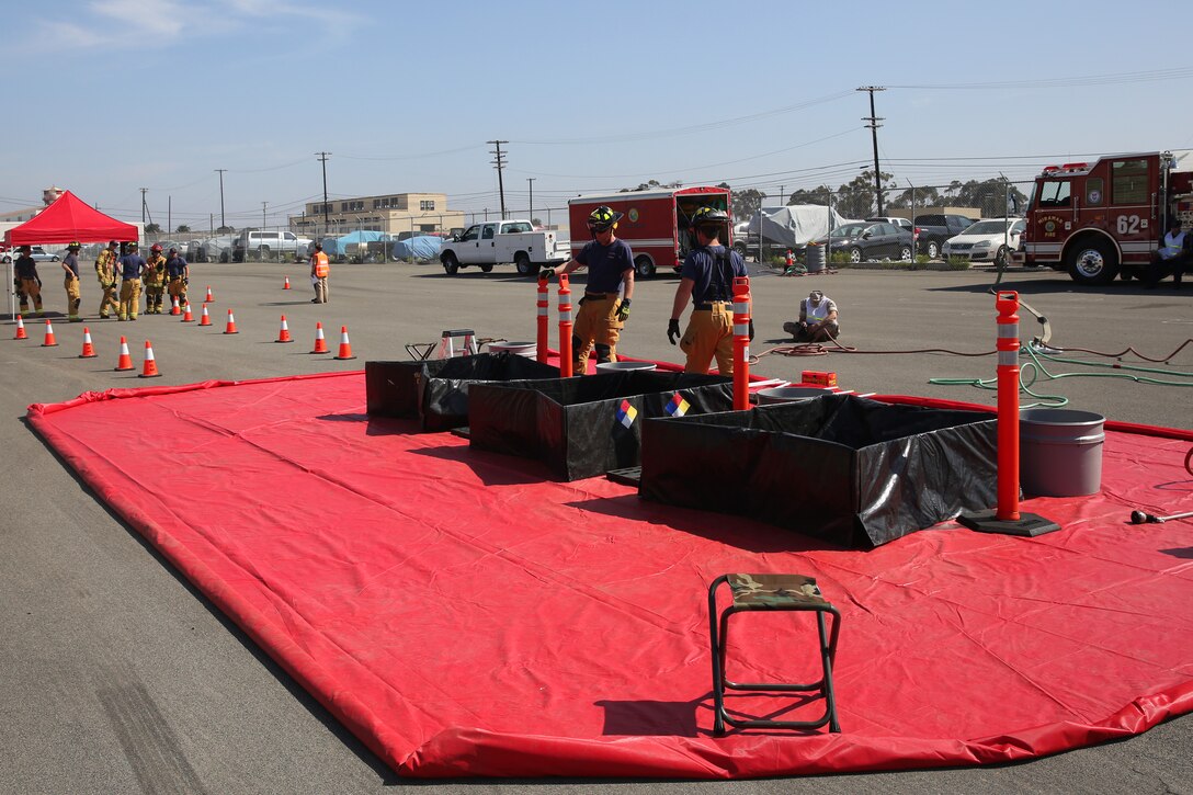 Firefighters with the Marine Corps Air Station Miramar Fire Department construct a decontamination site during a Biowatch exercise aboard MCAS Miramar, Calif., May 29. The exercise was held to test the effectiveness of interagency response to a biological incident.  