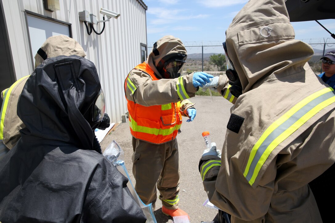 MARINE CORPS AIR STATION MIRAMAR, Calif. – Aircraft Rescue and Firefighting Marines collect water samples during an exercise aboard Marine Corps Air Station Miramar, Calif., May 29. The Marines collected the samples to send to the San Diego Vector Disease and Diagnostic Lab to test for a contaminant. 