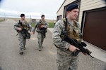 From right to left Senior Airman Scott Leithheiser, Senior Airman Trent Obrien, and Tech. Sgt. Cody Chick, all of the 219th Security Forces Squadron, return from the gate of a Minot Air Force Base, N.D., missile alert facility, after granting access to authorized personnel entering the facility May 20, 2014. 
