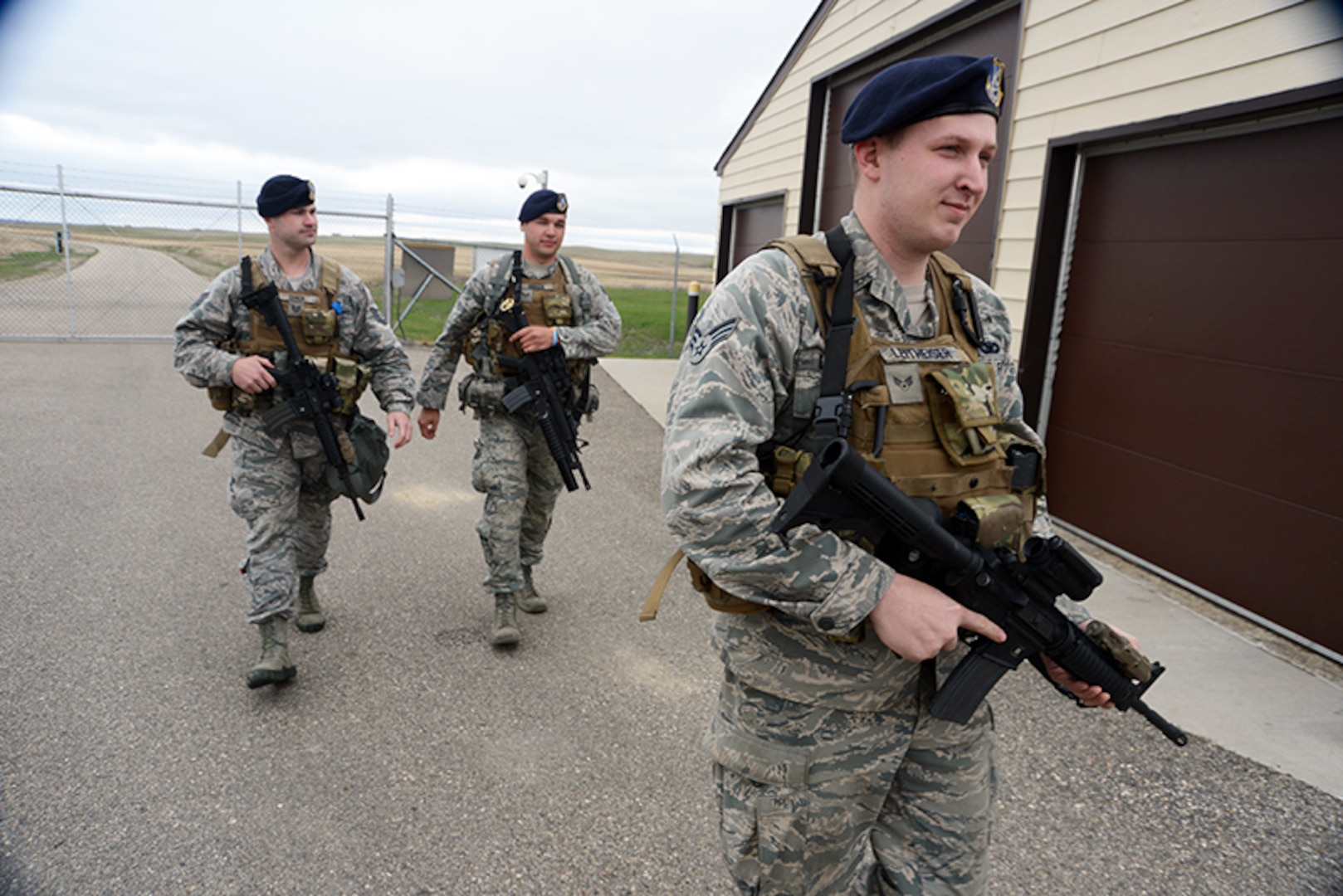 From right to left Senior Airman Scott Leithheiser, Senior Airman Trent Obrien, and Tech. Sgt. Cody Chick, all of the 219th Security Forces Squadron, return from the gate of a Minot Air Force Base, N.D., missile alert facility, after granting access to authorized personnel entering the facility May 20, 2014. 