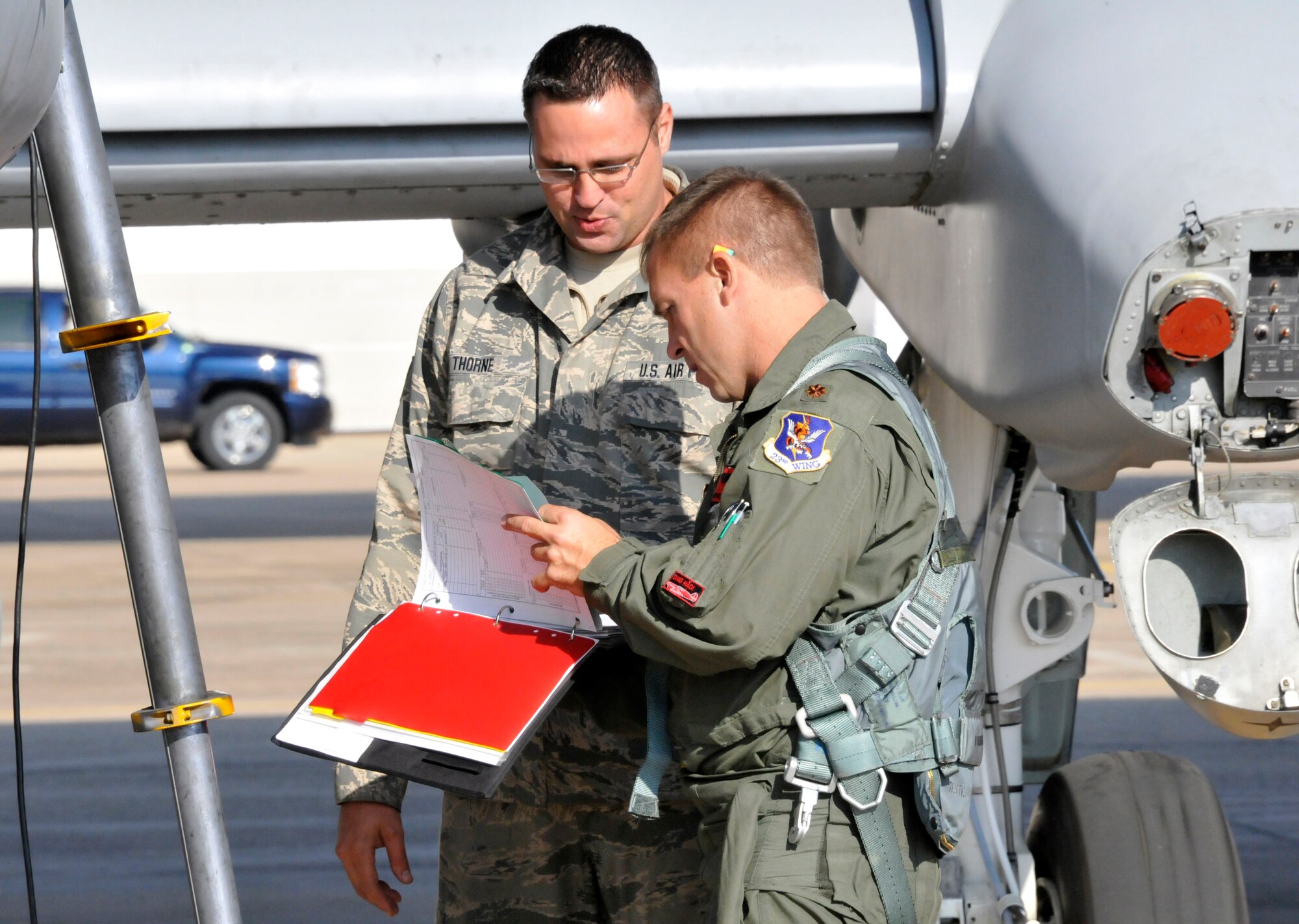 Tech Sgt. Shawn Thorne, a crew chief with the 188th Aircraft Maintenance Squadron, and Maj. Michael Roche, a pilot with the 76th Fighter Squadron, Moody Air Force Base, Georgia, review forms on an A-10C Thunderbolt II "Warthog" (Tail No. 586). The aircraft left Ebbing Air National Guard Base, Fort Smith, Arkansas. The aircraft was delivered from the 188th Fighter Wing to Moody Air Force Base, Georgia, April 18, 2014, as part of the 188th's mission conversion from the A-10 to a remotely piloted aircraft, intelligence and targeting mission. The 188th has three remaining A-10s on station. The final two aircraft are scheduled to leave the 188th June 7, 2014. (U.S. Air National Guard photo by Tech Sgt. Josh Lewis/Released)