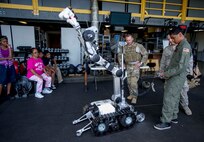 Kirby Balinski, a teenager battling Hodgkin’s Lymphoma, picks up a teddy bear during a demonstration of the Air Force medium sized robot at the 647th Civil Engineer Squadron Explosive Ordnance Disposal Flight facility on Joint Base Pearl Harbor-Hickam, Hawaii, May 29, 2014. Kirby was visiting the facility as part of the 15th Wing Pilot For a day Program, and was chosen to be a participant after being diagnosed with Hodgkin’s Lymphoma in October. (U.S. Air Force photo/Tech. Sgt. Terri Paden)