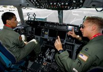 Kirby Balinski, a teenager battling Hodgkin’s Lymphoma, looks on as Capt. Damion Liu, a pilot in the 535th Airlift Squadron, answers questions about the cockpit of a C-17 Globemaster III as part of the Pilot For a Day program at Joint Base Pearl Harbor-Hickam, Hawaii, May 29, 2014. Kirby is a flying enthusiast whose passion for flying was born watching World War II pilots on the History Channel. (U.S. Air Force photo/Tech. Sgt. Terri Paden)