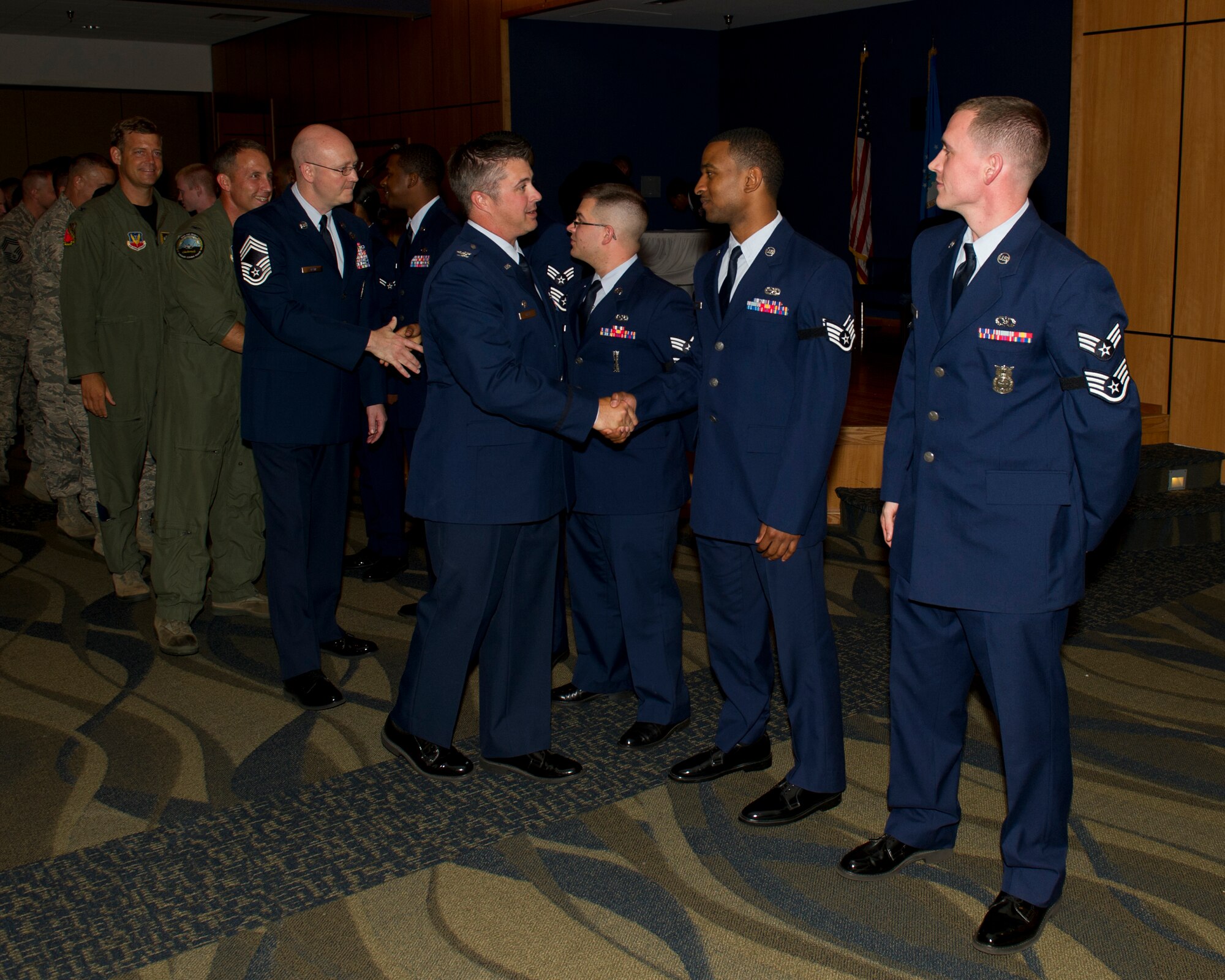 Col. David E. Graff, 325th Fighter Wing commander, congratulates Staff Sgt. Dorian D. Cruz from the 325th Maintenance Squadron May 30 during the June Promotion Ceremony at the Horizons Community Center. (U.S. Air Force photo by Senior Airman Christopher Reel) 