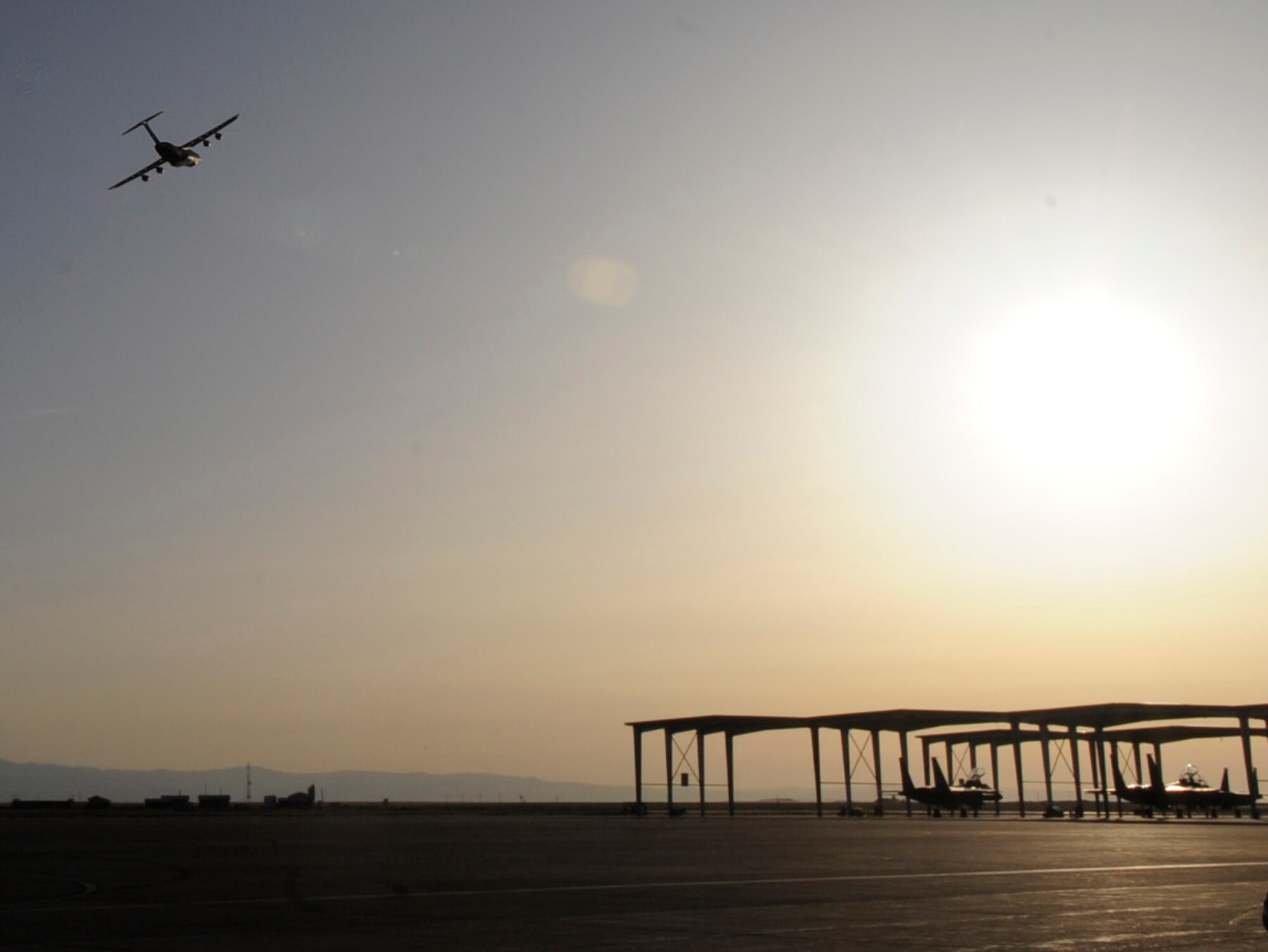 A C-5M Super Galaxy flies off into the sunset, May 29, 2014, at Mountain Home Air Force Base, Idaho. The Aircraft contains hundreds of Airmen from the 366th Fighter Wing, deploying to Pacific Air Forces and the U.S. Pacific Command. (U.S. Air Force photo by Senior Airman Caitlin Guinazu/Released) 