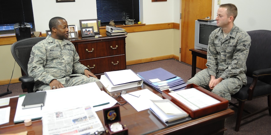 U.S. Air Force Chief Master Sgt. Eddie Webb, left, 7th Bomb Wing command chief, talks with Airman 1st Class Adam Disque, 7th Aerospace Medicine Squadron bioenvironmental technician May 15, 2014, at Dyess Air Force Base, Texas. Webb has implemented a new program where he spends two days a month with an Airman. This program assists Airmen in understanding what goes on at higher level Air Force by allowing them to be behind closed doors and experience first-hand the work put in by a command chief. (U.S. Air Force photo by Senior Airman Shannon Hall/Released)