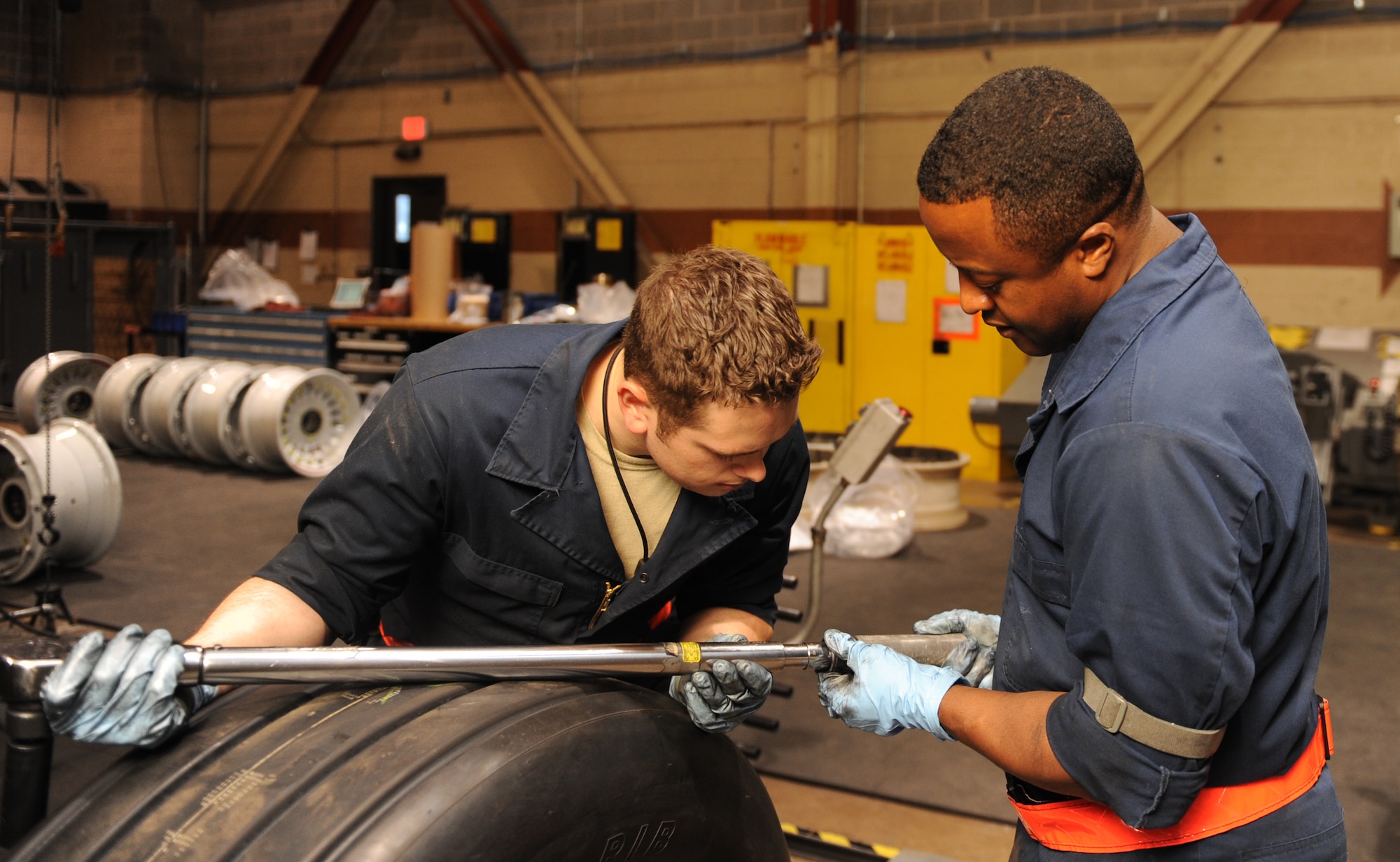 U.S. Air Force Senior Airman Briggen Baker, left, 7th Equipment Maintenance Squadron wheel and tire journeyman, and Chief Master Sgt. Eddie Webb, 7th Bomb Wing command chief, work together to correctly set a torque wrench April 29, 2014, at Dyess Air Force Base, Texas. Webb spent the day working in the wheel and tire shop as part of his new program, “Chief’s Turn to Learn.” The program offers Airmen the chance to show Chief Webb what they do on a daily basis to accomplish the Air Force mission. (U.S. Air Force photo by Airman 1st Class Autumn Velez/Released)
