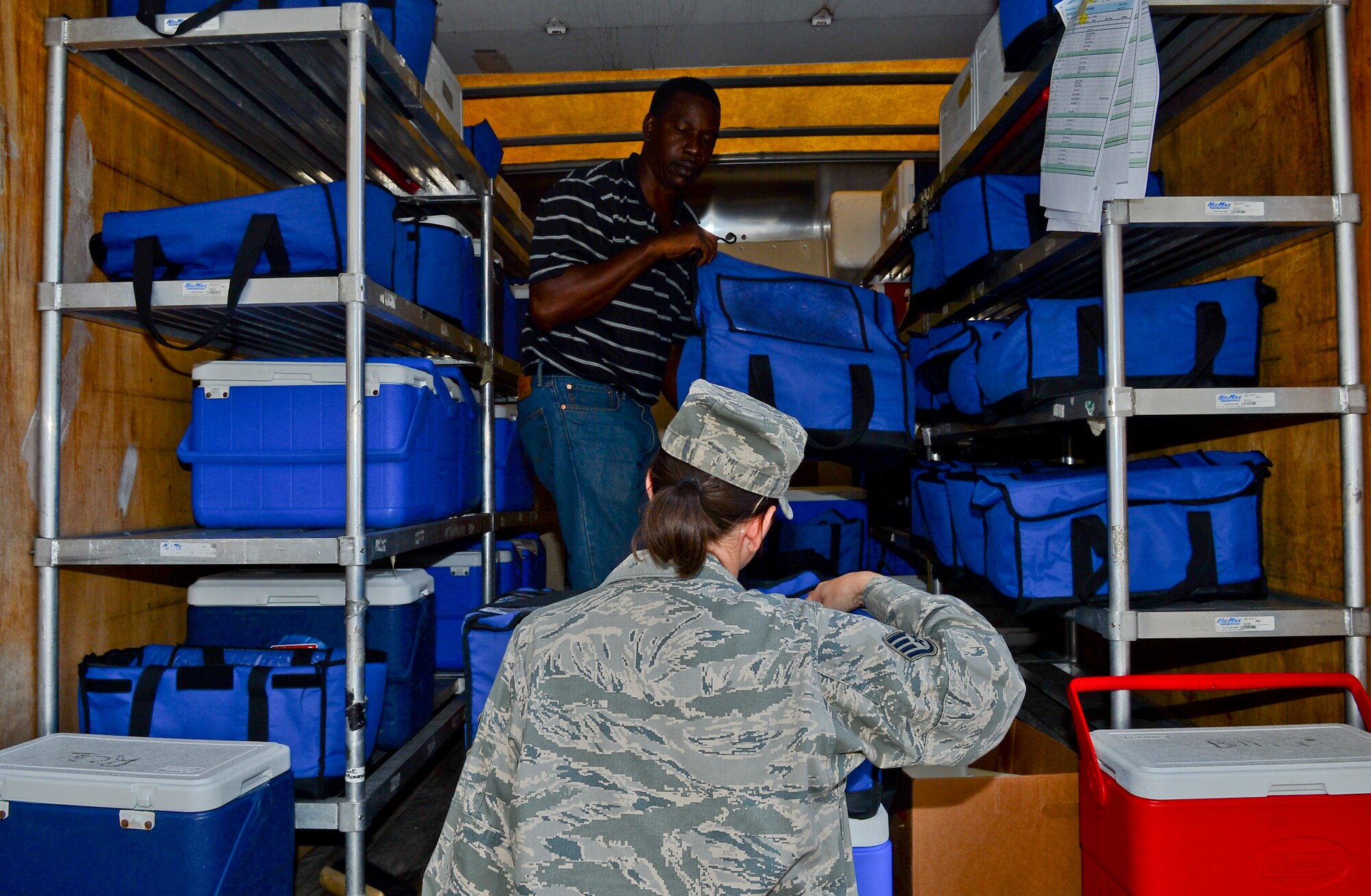 Staff Sgt. Katie Patterson, 6th Air Mobility Wing Meals on Wheels volunteer, recieves  meals to deliver to the elderly May 29, 2014 in Tampa, Fla. MOW of Tampa serve approximately 750 meals per day. (U.S. Air Force photo by Senior Airman Jenay Randolph/Released)