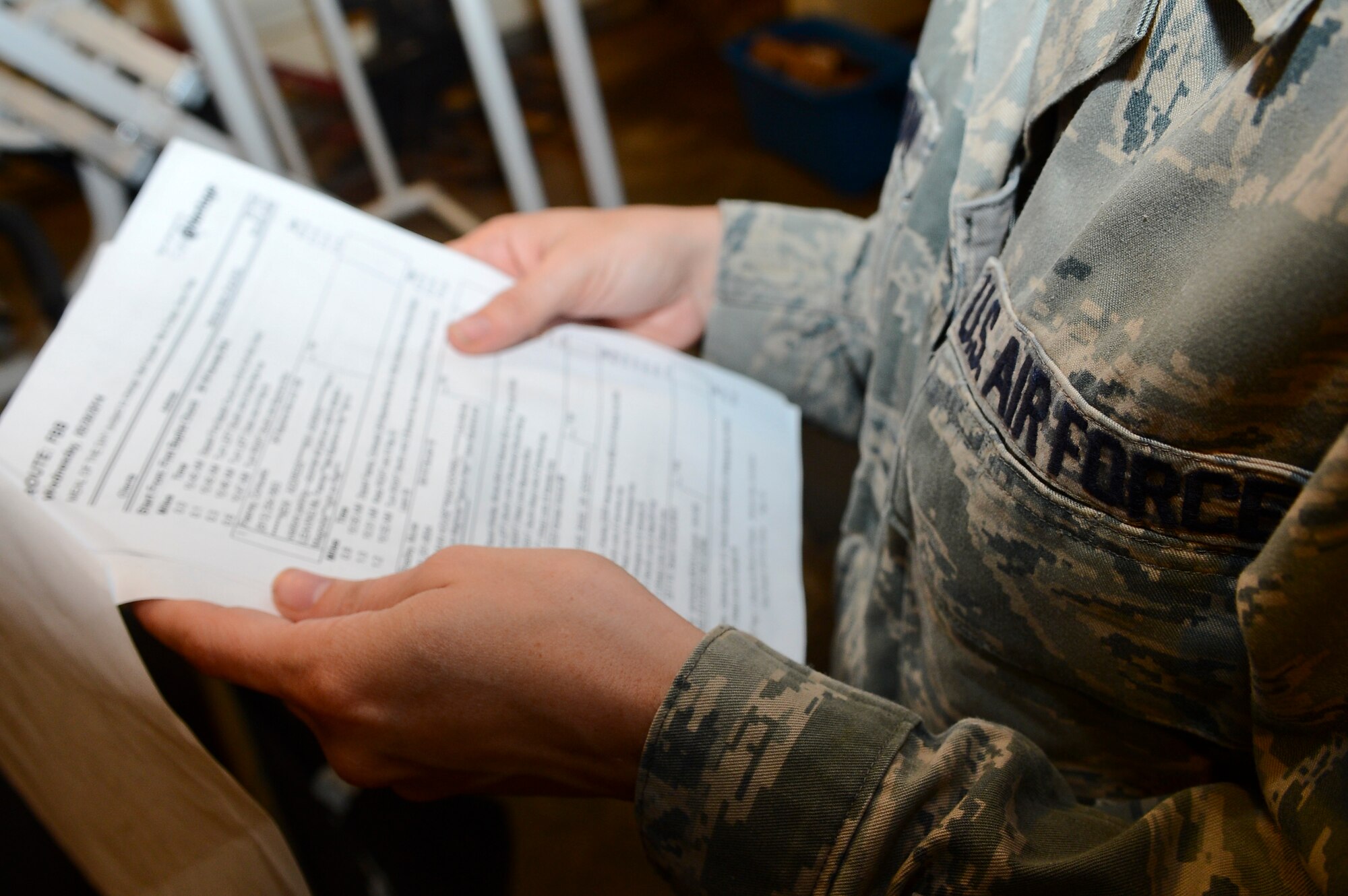 Staff Sgt. Katie Patterson, 6th Air Mobility Wing Meals on Wheels volunteer, reviews the route before delivering meals May 29, 2014 in Tampa, Fla. The route adopted has approximately 15 people assigned to it and can fluctuate from week to week. (U.S. Air Force photo by Senior Airman Jenay Randolph/Released)