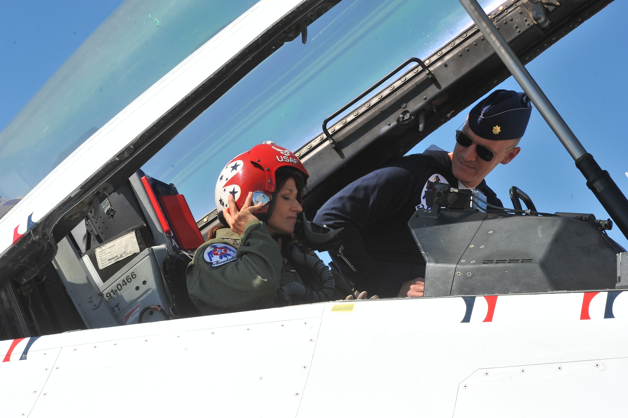 Maj. Michael Fischer, U. S. Air Force Thunderbirds pilot, prepares Robyn Nance, KXLY news anchor, for a ride in the F-16 Fighting Falcon before SkyFest 2014 at Fairchild Air Force Base, Wash., May 30, 2014.  The Thunderbirds have flown the F-16 Fighting Falcon since August 1982, more than half of the team's history. SkyFest is Fairchild’s air show and open house, giving the local and regional community the opportunity to view Airmen and our resources. (U.S. Air Force photo by Staff Sgt. Veronica Montes)