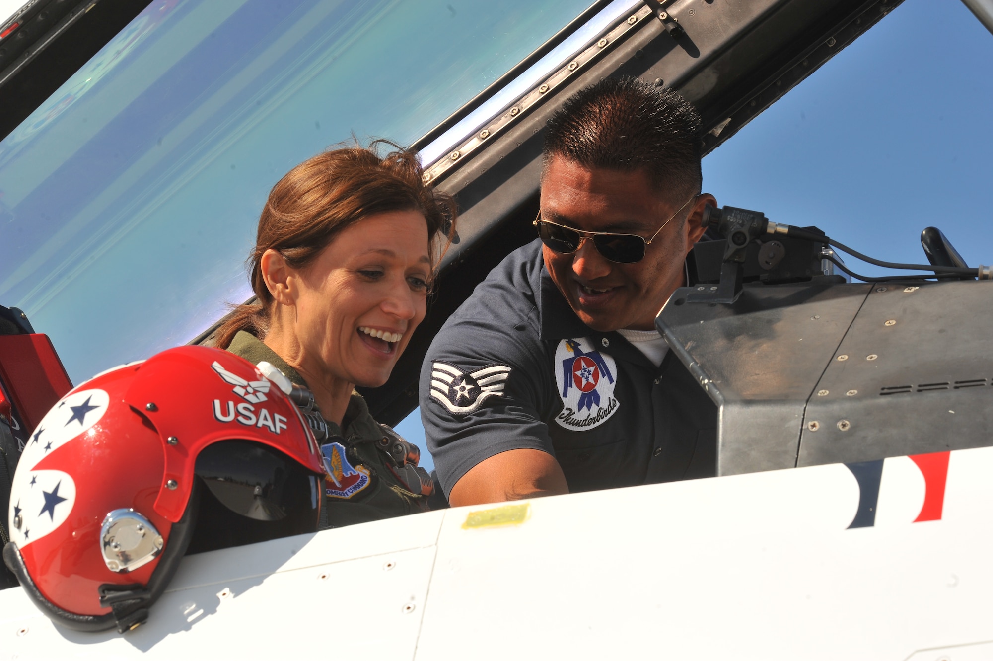 Staff. Sgt. Mark Mira, U.S. Air Force Thunderbirds crew chief, assists Robyn Nance, KXLY news anchor, for her flight in the F-16 Fighting Falcon before SkyFest 2014 at Fairchild Air Force Base, Wash., May 30, 2014.  The Thunderbirds is an Air Combat Command unit composed of eight pilots, including six demonstration pilots, four support officers, three civilians and more than 130 enlisted personnel performing in 25 career fields. (U.S. Air Force photo by Staff Sgt. Veronica Montes)
