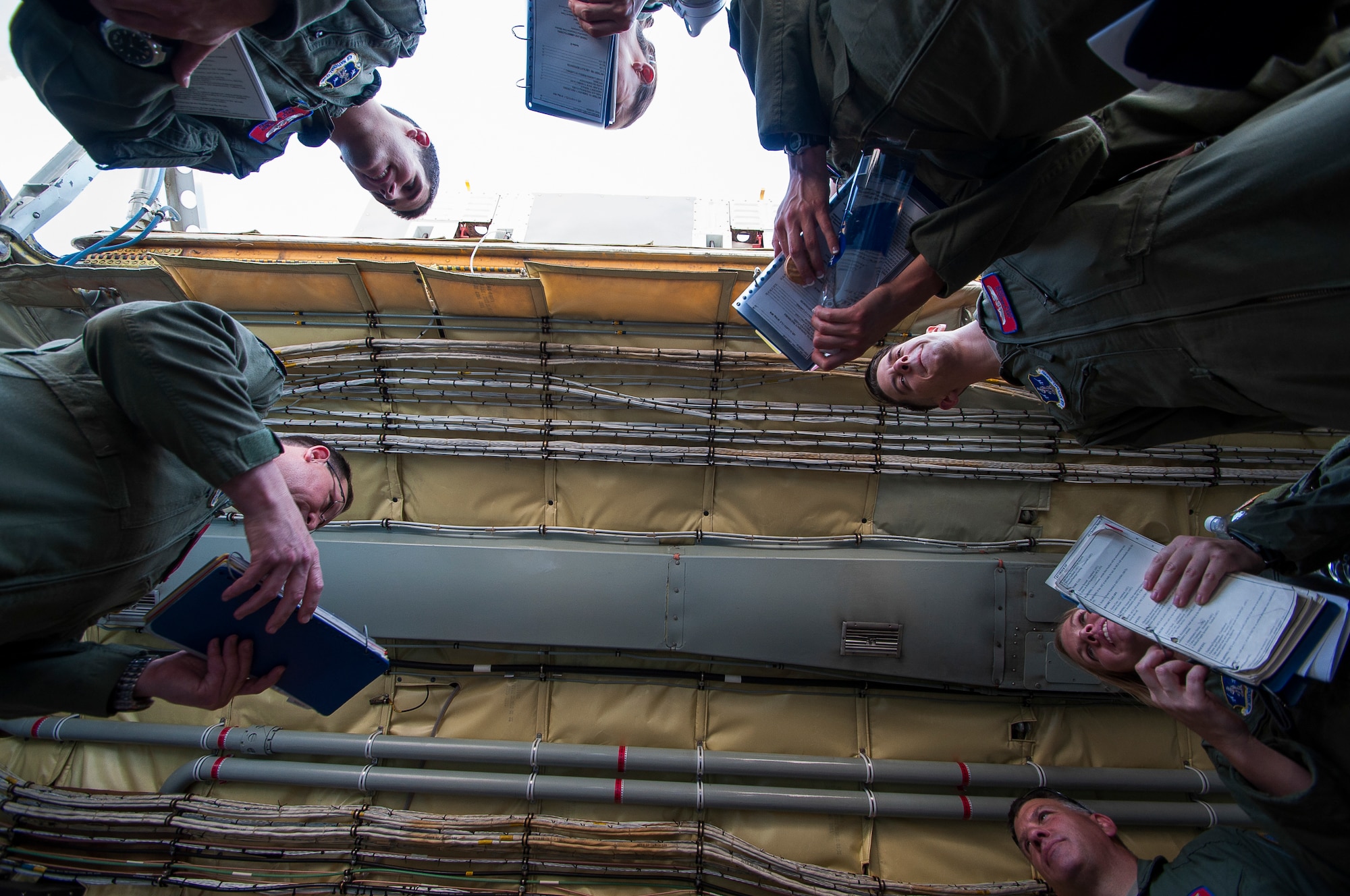 Lieutenant Colonel Mark D. Hole, left, of the 185th Oklahoma Air National Guard Air Refueling Squadron briefs the crew prior to flying a joint medical and refueling mission on May 29th, 2014. (U.S. Air Force Photo/Senior Airman Mark Hybers)