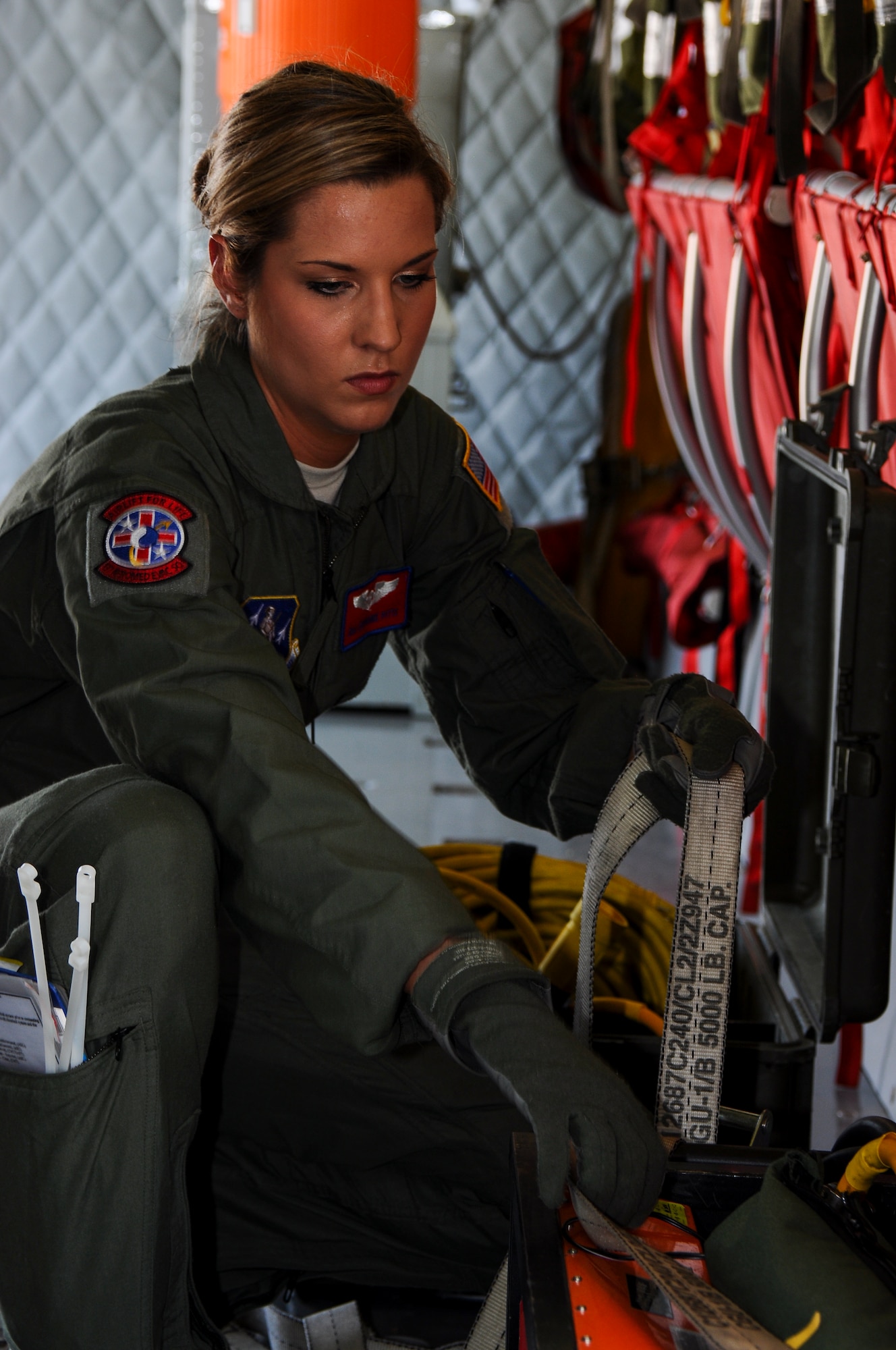 Senior Airman Stephanie Pitts of the 137th Oklahoma Air National Guard Aeromedical Evacuation Squadron secures medical equipment to the floor of a KC-135 in preparation for a joint medical and refueling mission on May 29th, 2014. (U.S. Air Force Photo/Senior Airman Mark Hybers)