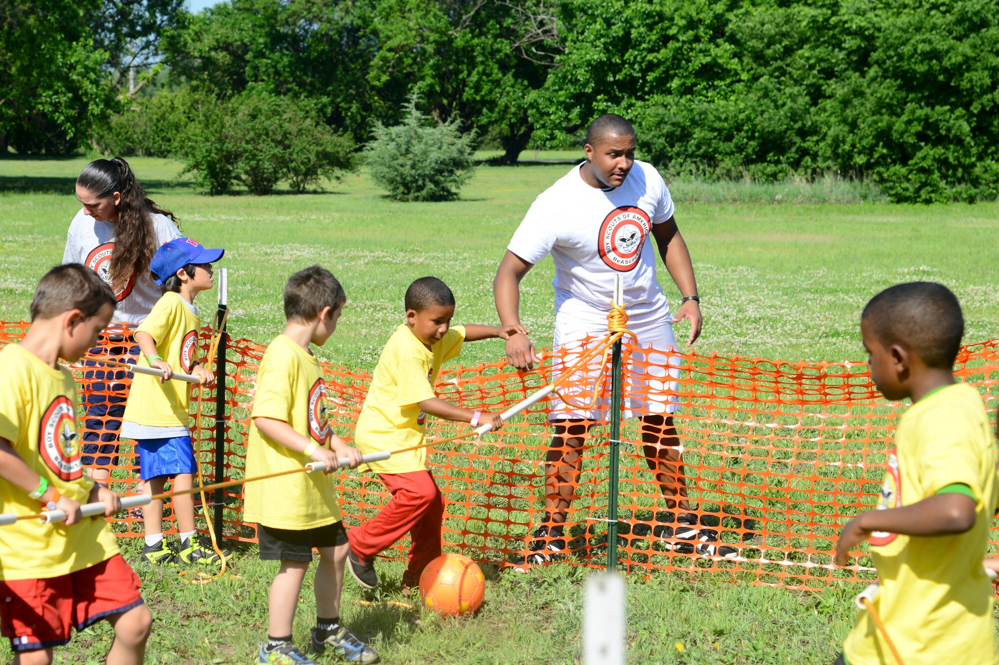 Senior Airman David Tolliver, 15th Operational Weather Squadron weather specialist, referees an improvised game of “human foosball,” May 28, 2014, at the Jim James Memorial 101 Club, at Wichita, Kan. Approximately 400 kids from 60 schools throughout Wichita participated in the 2014 Boy Scouts of America Awareness Camp, an outreach program for kids identified to come from a lower-economic background. (U.S. Air Force photo/Airman 1st Class John Linzmeier)