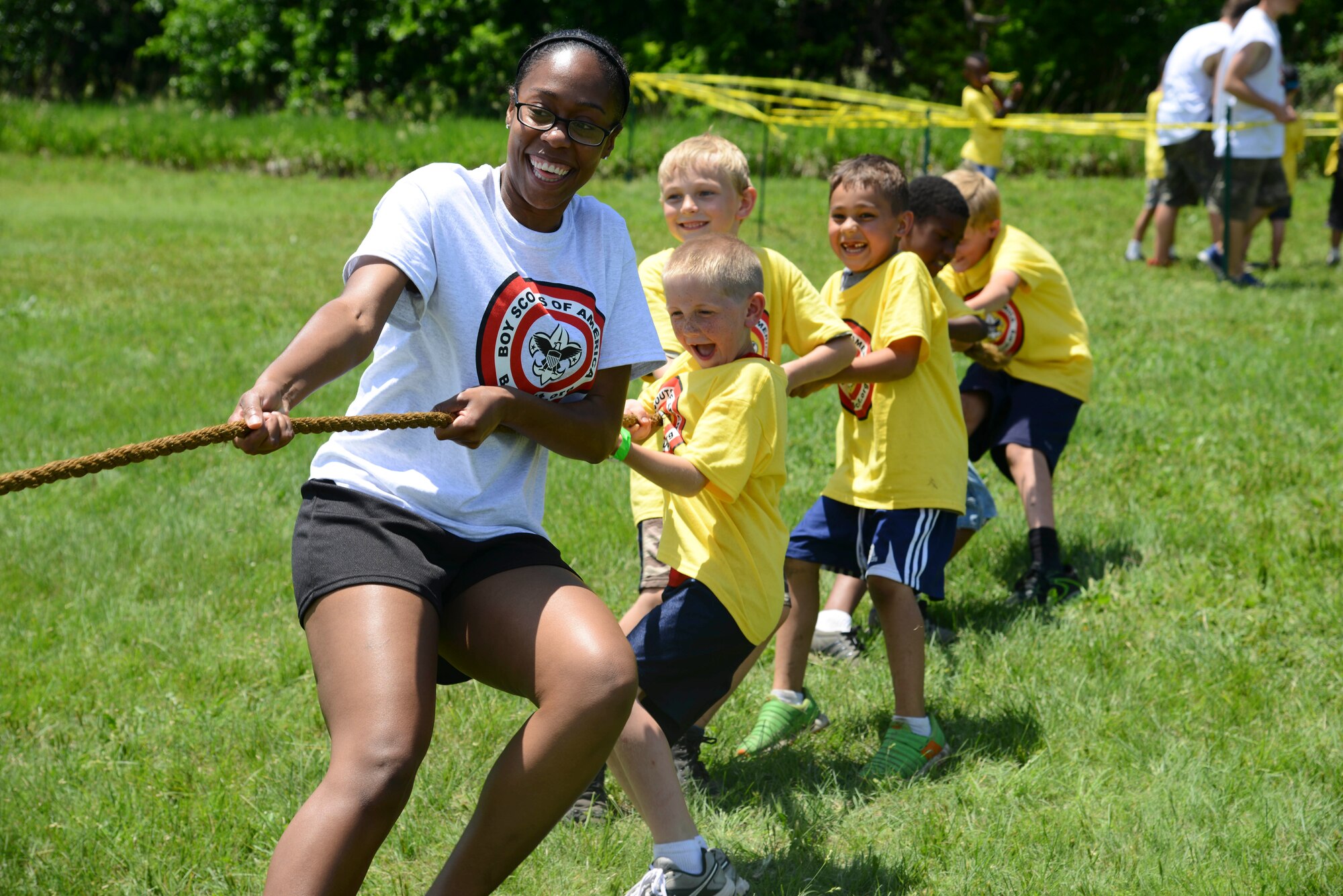 Airman 1st Class Brittany Bryant, 22nd Operations Support Squadron airfield management journeyman, joins kids in a game of tug-of-war, May 28, 2014, at the Jim James Memorial 101 Club, at Wichita, Kan. Boys, ages six through 10, were led through several outdoor activities during the 2014 Boy Scouts of America Awareness Camp. (U.S. Air Force photo/Airman 1st Class John Linzmeier)