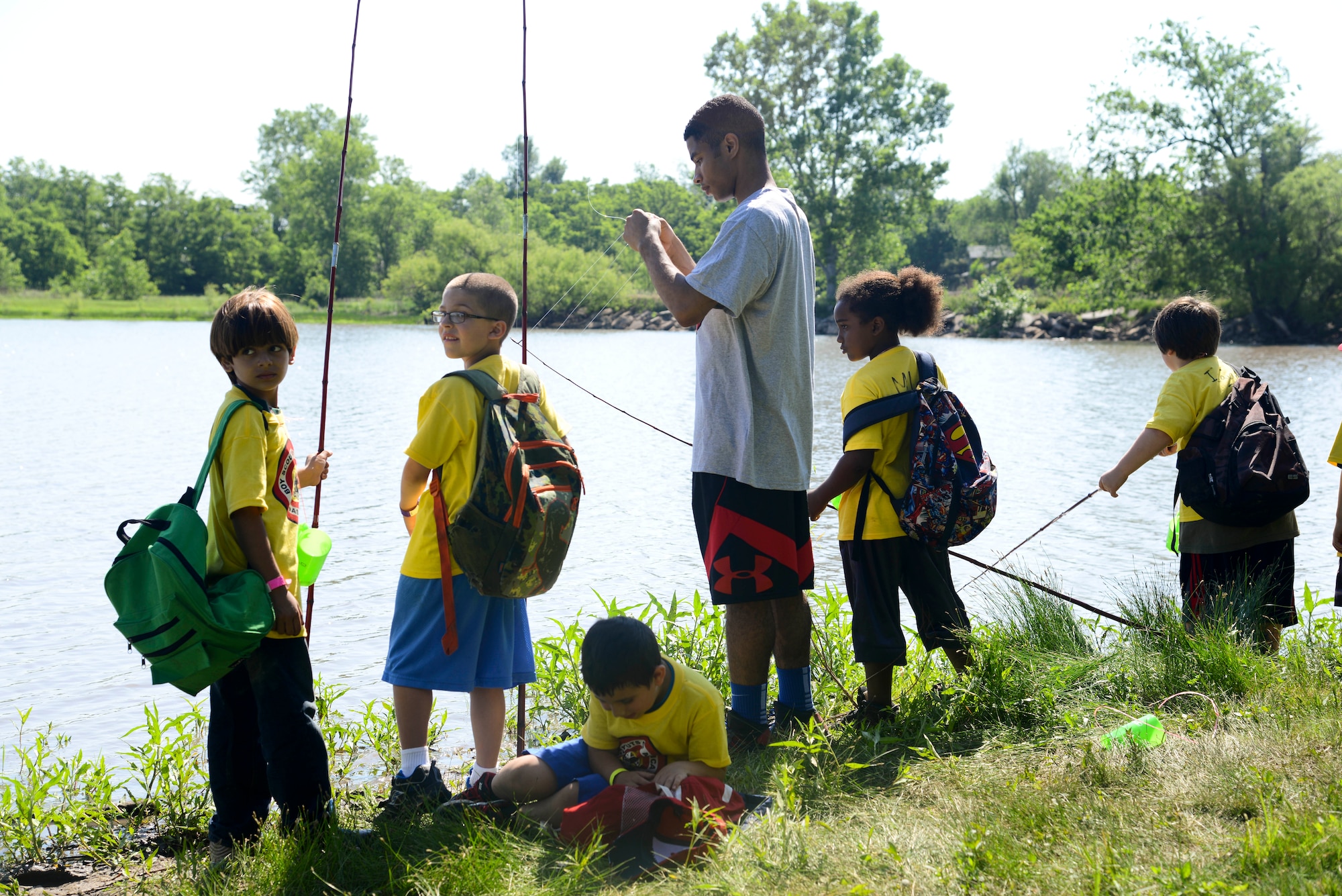 Airman 1st Class Udoka Addy, 22nd Maintenance Squadron aerospace ground equipment apprentice, helps bait a fishing line, May 28, 2014, at the Jim James Memorial 101 Club, at Wichita, Kan. He and other volunteers from McConnell Air Force Base led children through various outdoor activities during the 2014 Boy Scouts of America Awareness Camp. (U.S. Air Force photo/Airman 1st Class John Linzmeier)