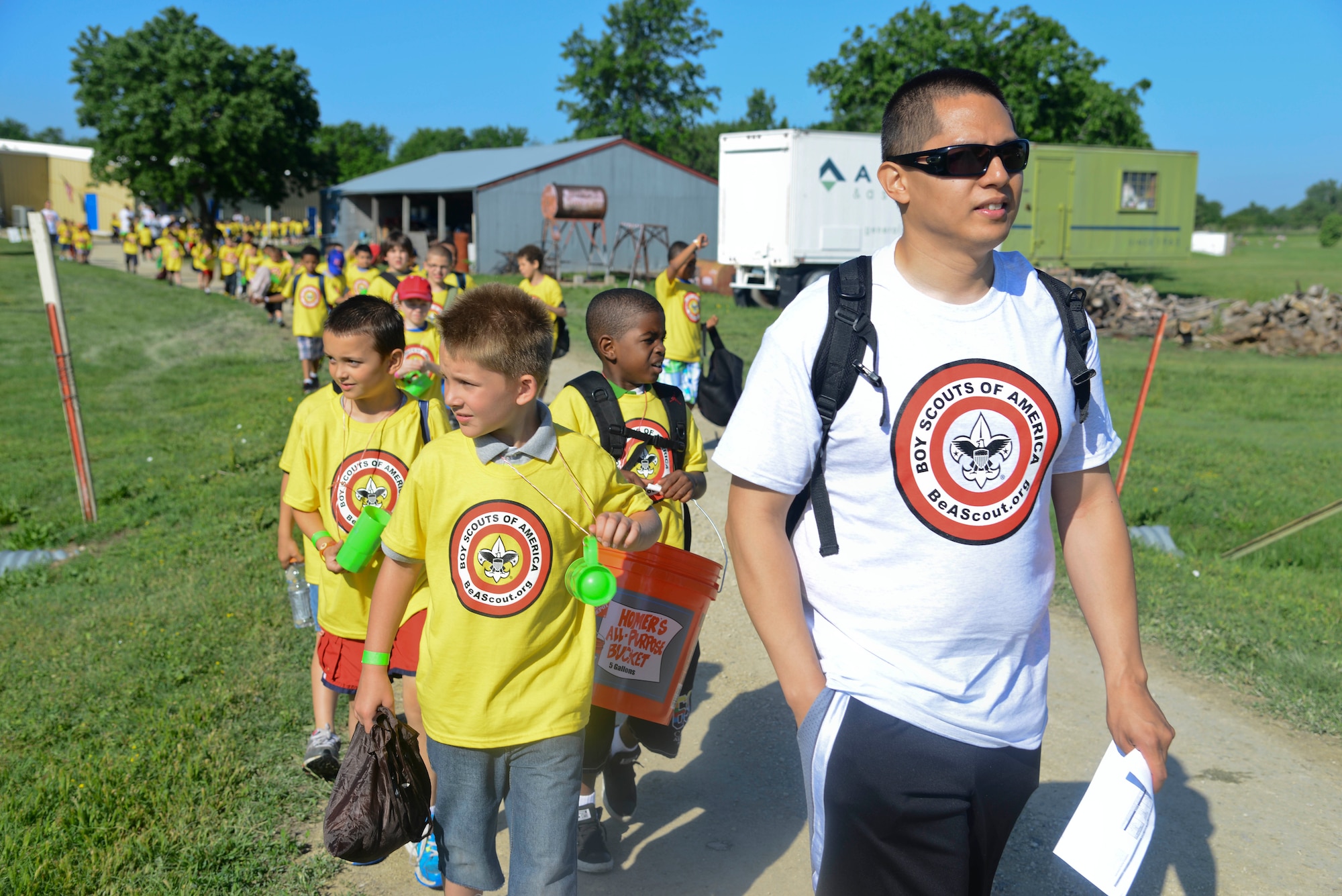 Senior Airman Robert Calvo, 22nd Communications Squadron airfield systems journeyman, leads a group of kids, May 28, 2014, at the Jim James Memorial 101 Club, at Wichita, Kan. He and 33 other volunteers from McConnell Air Force Base helped run the 2014 Boy Scouts of America Awareness Camp, leading nearly 400 boys through three days of outdoor activities. (U.S. Air Force photo/Airman 1st Class John Linzmeier)
