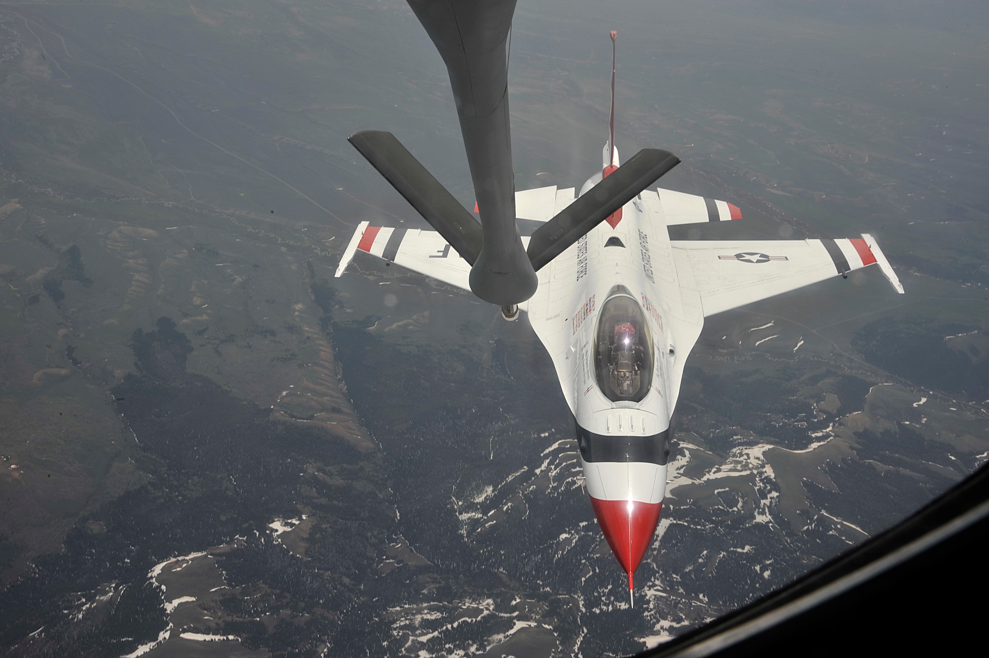 A U.S. Air Force Thunderbird approaches the boom of a KC-135 Stratotanker to receive fuel  over Colorado, May 29, 2014. The KC-135 escorted the Thunderbird team to it's home station at Fairchild Air Force Base, Wash., in preparation for Skyfest 2014, Fairchild's open house. (U.S. Air Force photo by Senior Airman Mary O'Dell/Released)