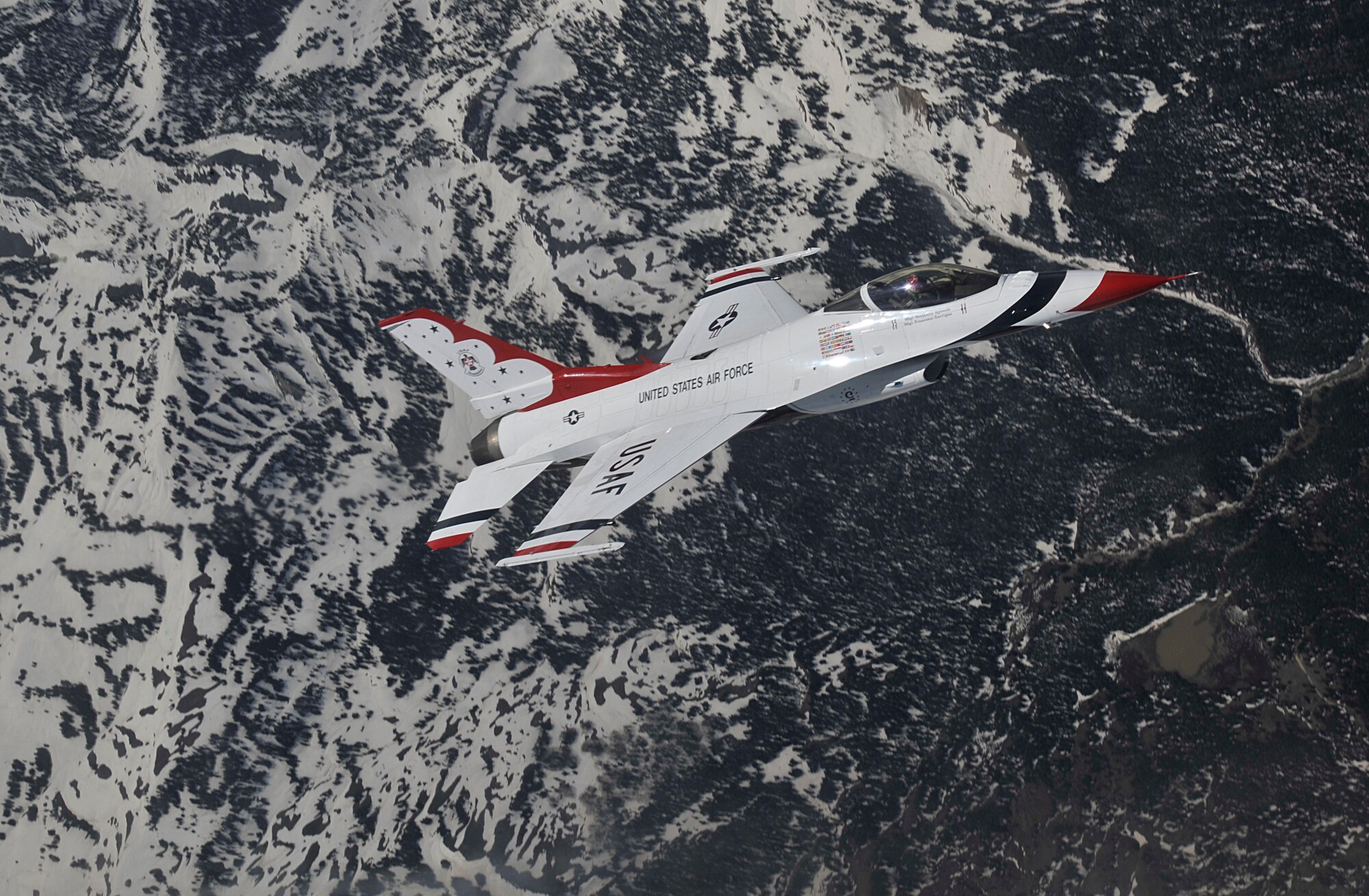 A U.S. Air Force Thunderbird flies over Colorado after receiving fuel from a KC-135 Stratotanker, May 29, 2013. The KC-135, assigned to Fairchild Air Force Base, Wash., refueled the Thunderbird team while escorting them to Fairchild for SkyFest 2014. The Thunderbirds squadron is an Air Combat Command unit composed of eight pilots (including six demonstration pilots), four support officers, three civilians and more than 130 enlisted personnel performing in 25 career fields. (U.S. Air Force photo by Senior Airman Mary O'Dell/Released)