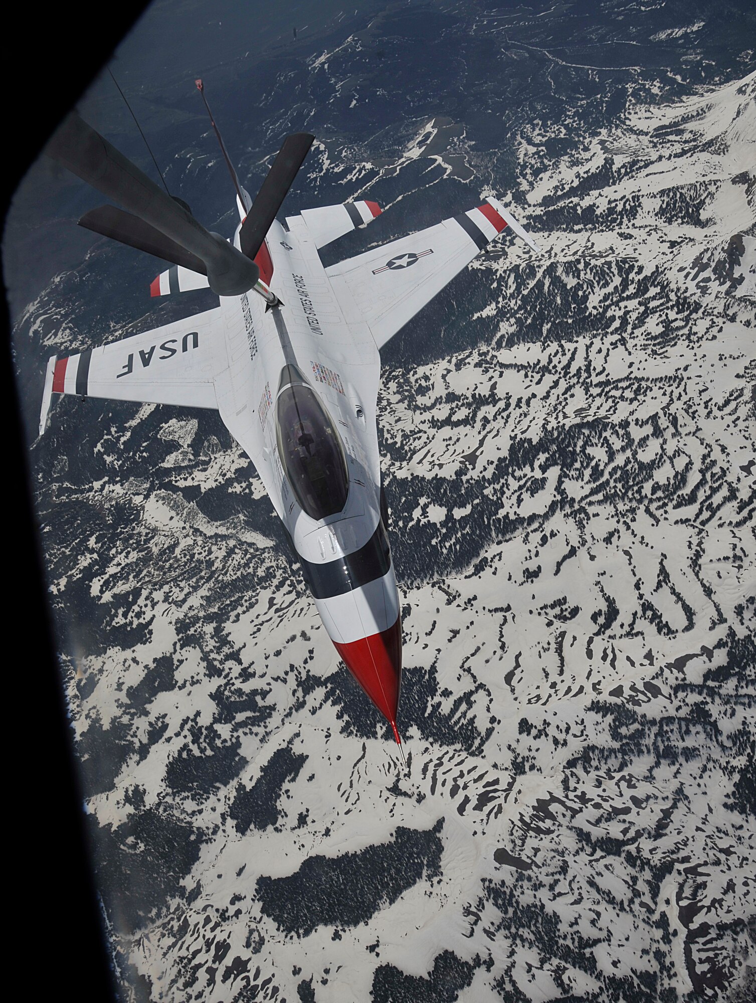 A U.S. Air Force Thunderbird attaches to the boom of a KC-135 Stratotanker to receive fuel mid-air over Colorado, May 29, 2014. The KC-135 escorted the Thunderbird team to it's home station at Fairchild Air Force Base, Wash., in preparation for SkyFest 2014, Fairchild's open house and air show. (U.S. Air Force photo by Senior Airman Mary O'Dell/Released)