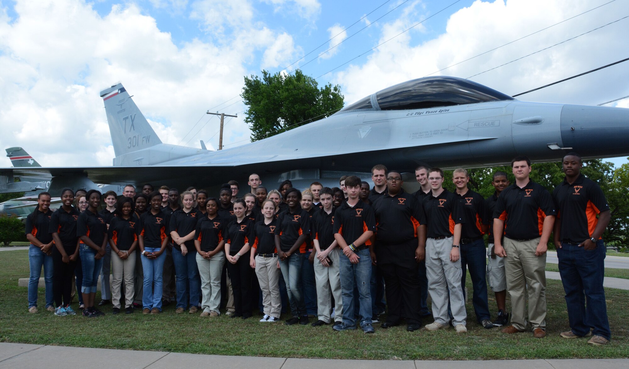 Members of the Junior Reserve Officer Training Corps, Madison Central High School, Madison, Mississippi, stand in front of an F-16 fighter jet static display, May 29, 2014, Naval Air Station Fort Worth Joint Reserve Base, Texas. The students are visiting the 301st Fighter Wing to learn about the different career fields the Air Force has to offer. (U.S. Air Force photo by Staff Sgt. Samantha A. Mathison)