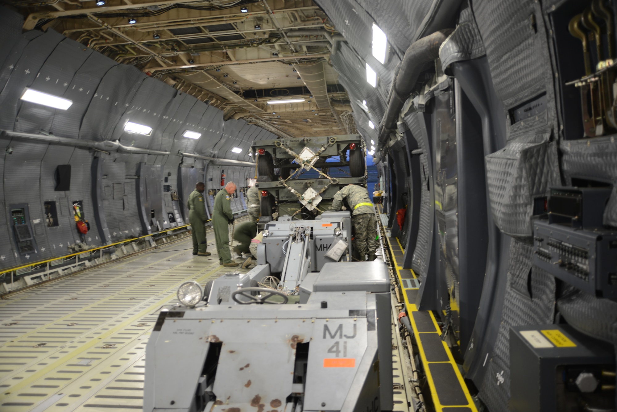 AIrmen from the 709th Airlift Squadron, Dover Air Force Base, Del., and 366th Logistics Readiness Squadron load equipment inside a C-5M Super Galaxy for flight May 28, 2014, at Mountain Home Air Force Base, Idaho. Mountain Home Airmen, including aircrew, medical, logistics and maintenance personnel, as well as F-15E Strike Eagles from the 391st Fighter Squadron will support Pacific Air Forces and the U.S. Pacific Command.(U.S. Air Force photo by Senior Airman Benjamin Sutton/Released)