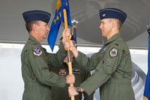 U.S. Air Force Col. Thomas Dorl (right) assumes command of the 347th Rescue Group as he receives the unit guidon from Col. Chad Franks, 23d Wing commander, during a change of command ceremony May 29, 2014, at Moody Air Force Base, Ga. Dorl arrived to Moody after two years of study at Maxwell Air Force Base’s Air War College. (U.S. Air Force photo by Airman Dillian Bamman/Released) 
