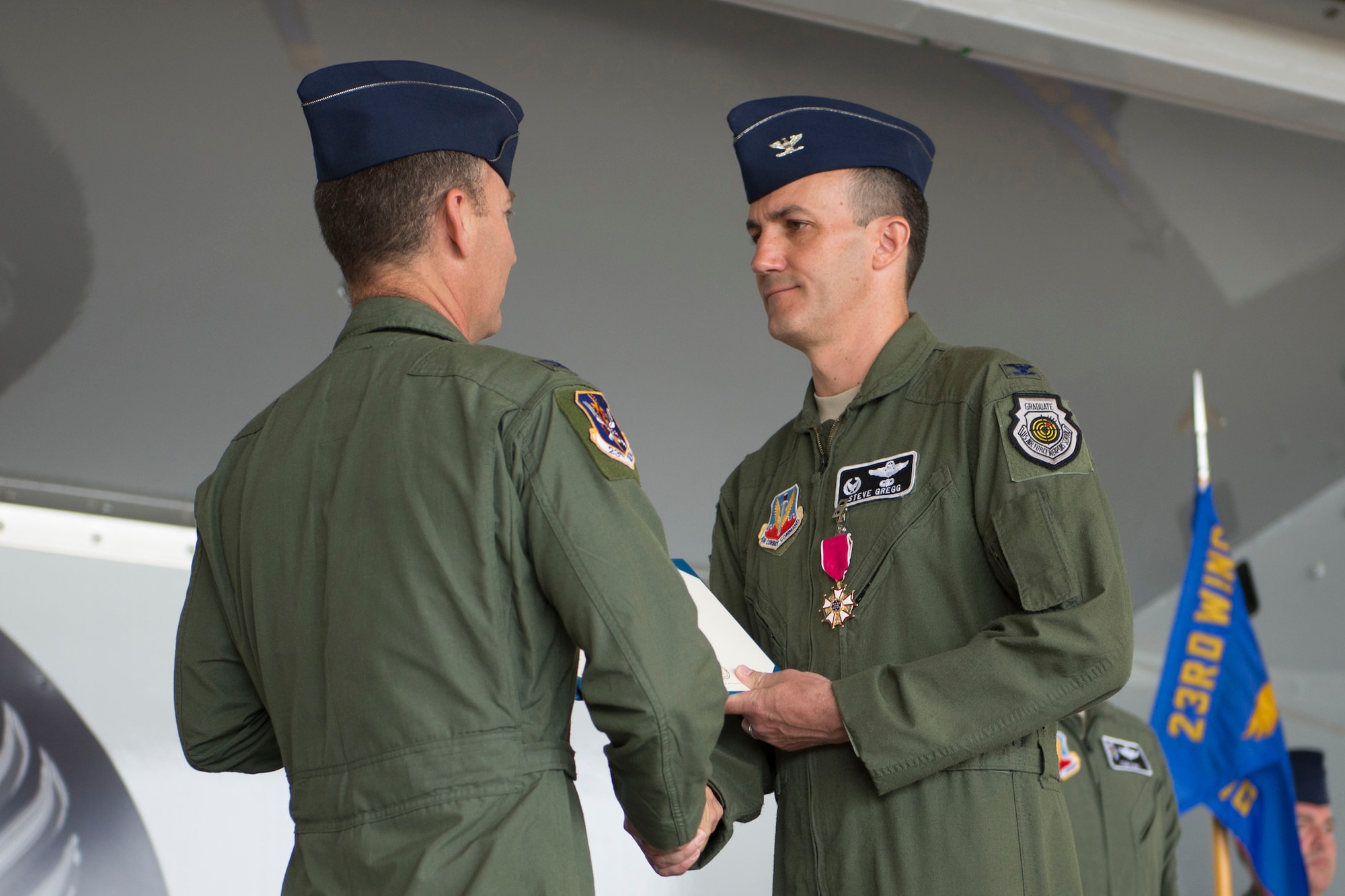U.S. Air Force Col. Steven Gregg (right) receives a Legion of Merit award certificate from Col. Chad Franks, 23d Wing commander, during a 347th Rescue Group change of command ceremony May 29, 2014, at Moody Air Force Base, Ga. Gregg served as the 347th RQG commander for two years and will soon work for the Foreign Military Sales program in Baghdad, Iraq. (U.S. Air Force photo by Airman Dillian Bamman/Released)