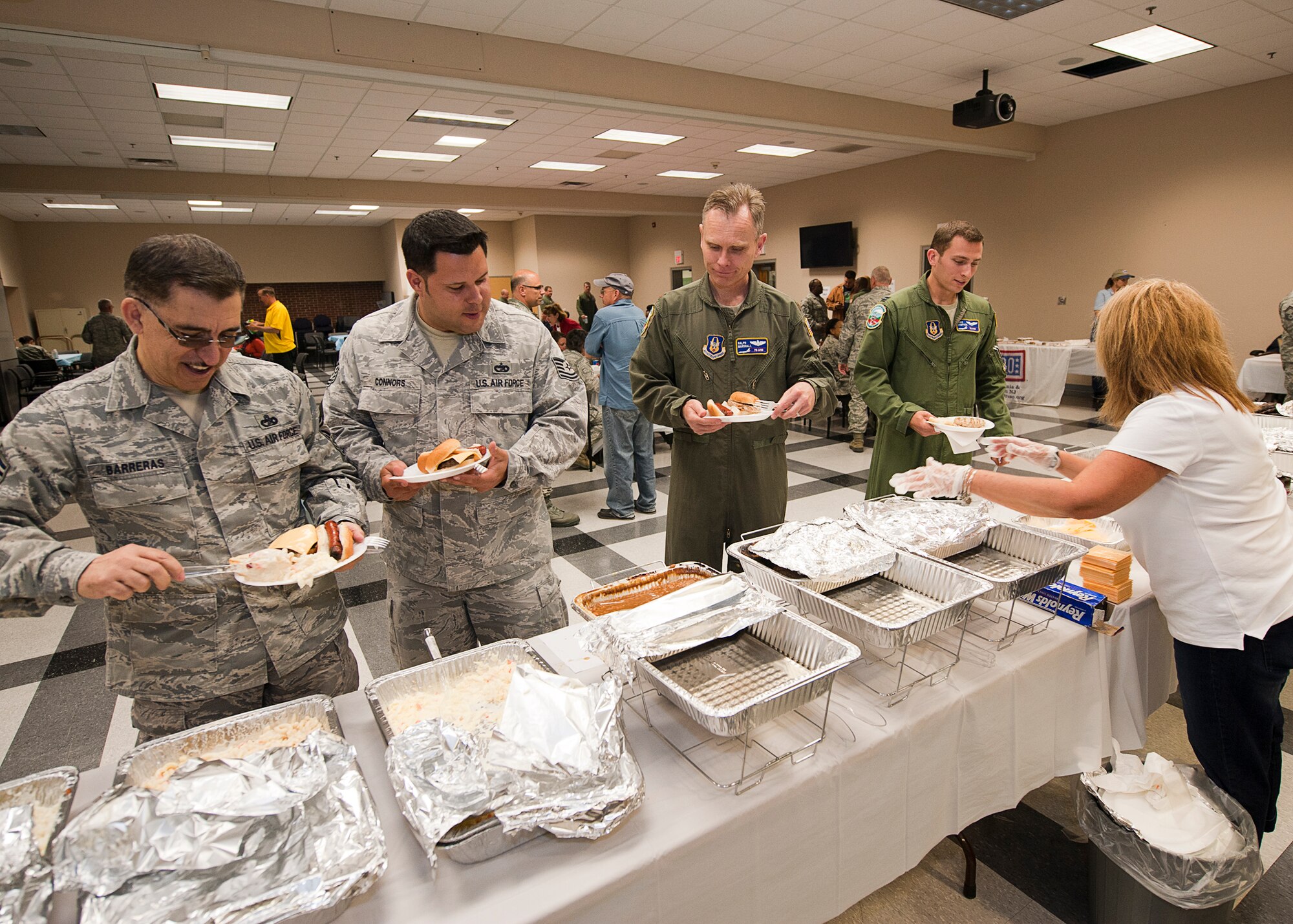 Members of the 514th Air Mobility Wing fill their plates with food prepared by the Point Pleasant Elks Lodge during the 2nd Annual Hot Diggity Dog Day luncheon, May 29, here(U.S. Air Force photo/Christian DeLuca). 