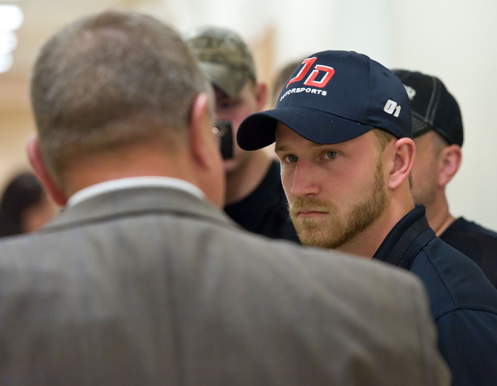 Jeffrey Earnhardt, right, NASCAR Nationwide Series driver of the No. 4 JD Motorsports Chevrolet, listens to James Canik, Armed Forces Medical Examiner System deputy director for administration, facilities and support, Armed Forces DNA Identification Laboratory, May 28, 2014, at Dover Air Force Base, Del. Earnhardt was briefed on how mitochondrial DNA is used to identify remains as part of forensic DNA testing procedures. (U.S. Air Force photo/Roland Balik)