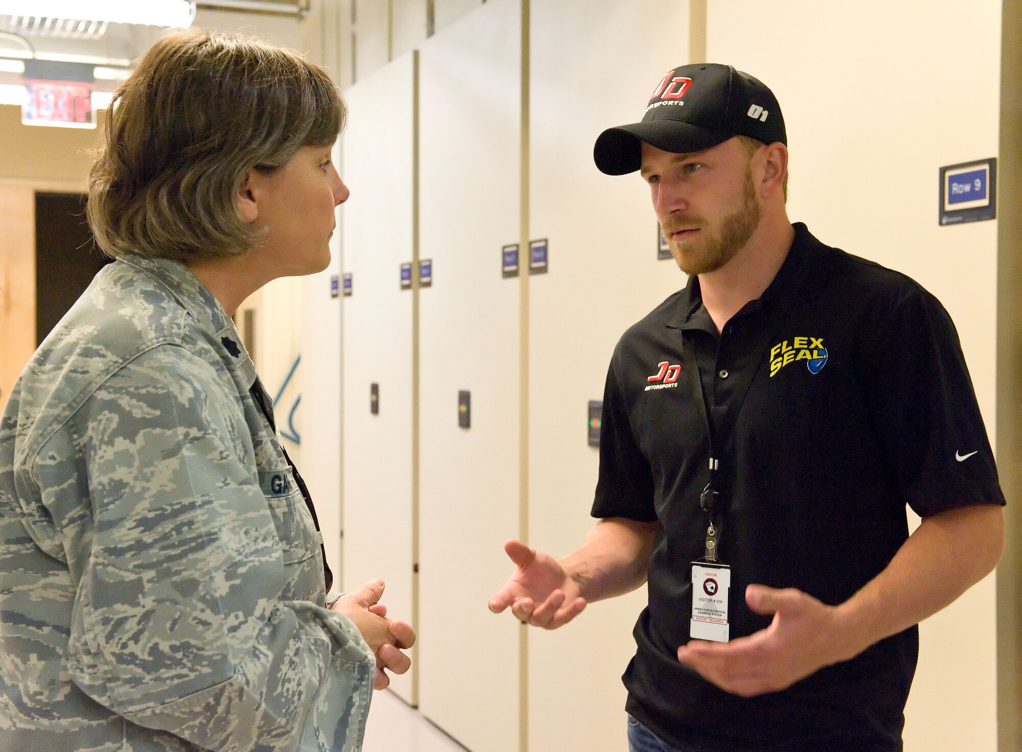 Jeffrey Earnhardt, right, NASCAR Nationwide Series driver for JD Motorsports, talks with Lt. Col. Laura Garner, left, Armed Forces DNA Identification Laboratory deputy director, May 28, 2014, at Dover Air Force Base, Del. Earnhardt and members of his crew received a briefing and toured the Armed Forces Medical Examiner System facility. (U.S. Air Force photo/Roland Balik)

