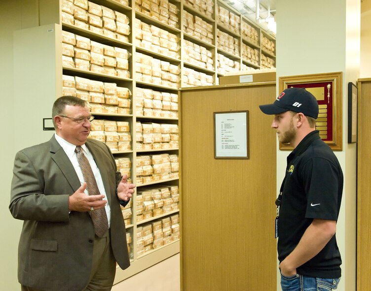Jeffrey Earnhardt, right, NASCAR Nationwide Series driver of the No. 4 JD Motorsports Chevrolet, listens to James Canik, Armed Forces Medical Examiner System deputy director for administration, facilities and support, Armed Forces DNA Identification Laboratory, May 28, 2014, at Dover Air Force Base, Del. Earnhardt received a briefing on DNA samples stored at AFMES. (U.S. Air Force photo/Roland Balik)