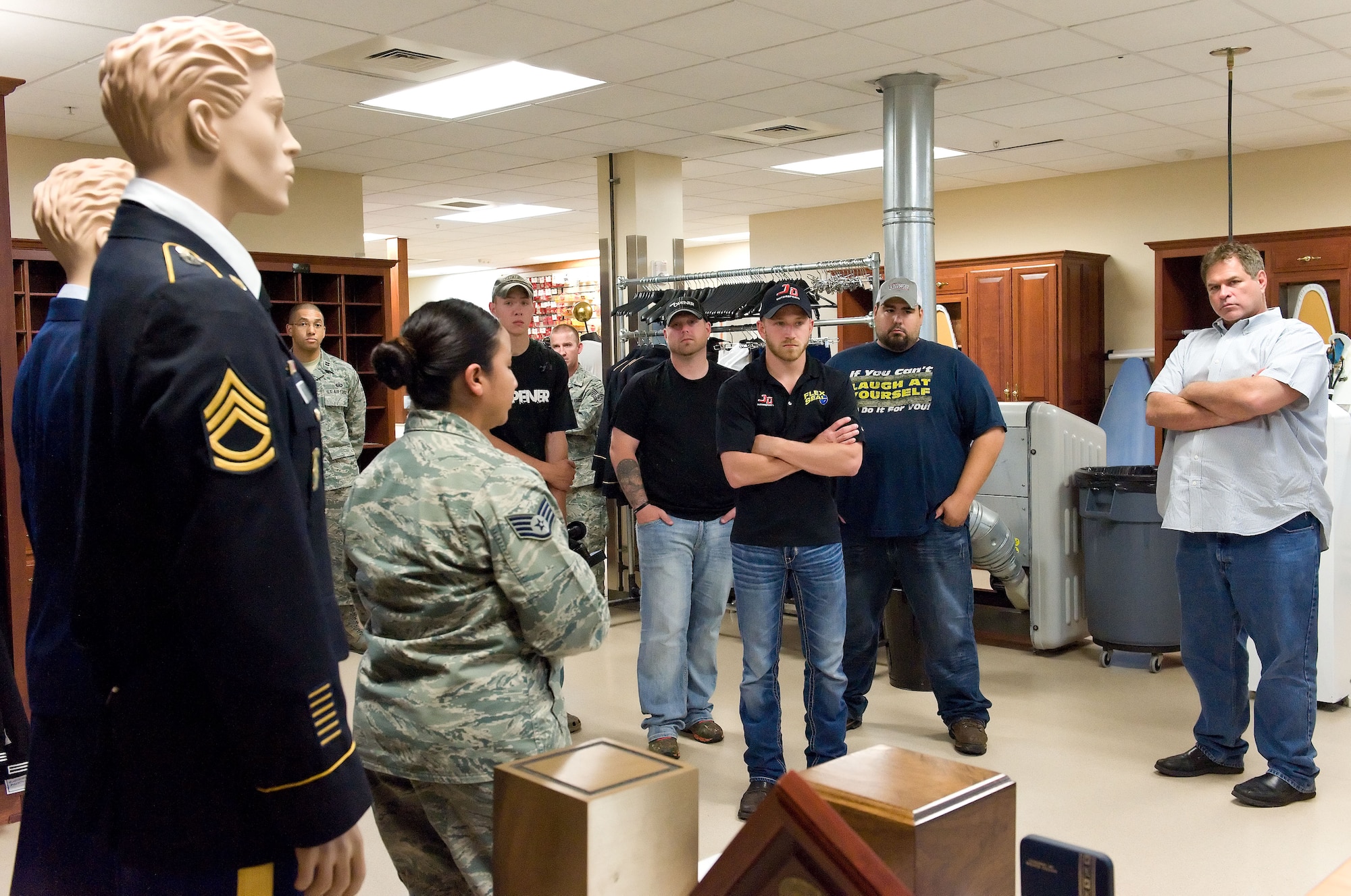 Jeffrey Earnhardt, NASCAR Nationwide Series driver of the JD Motorsports No. 4 Chevrolet Camaro, listens as Staff Sgt. Connie Martinez, Air Force Mortuary Affairs Operations uniform section NCO in charge, explains the mission of the uniform section during an orientation of the mortuary, May 28, 2014, at Dover Air Force Base, Del.  (U.S. Air Force photo/Roland Balik)
