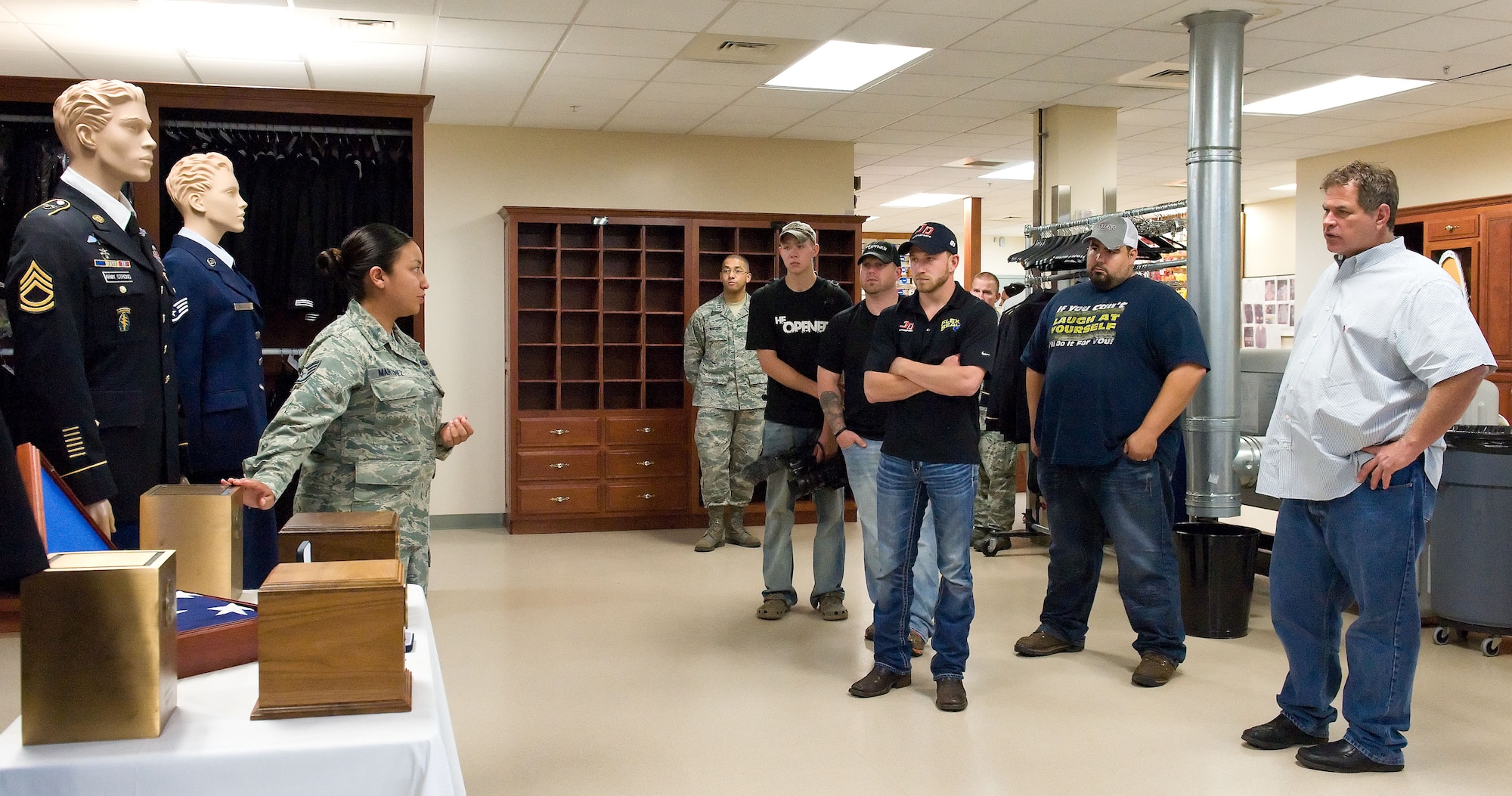 Staff Sgt. Connie Martinez, Air Force Mortuary Affairs Operations uniform section NCO in charge, highlights the flag cases presented to families of fallen service members to Jeffrey Earnhardt and his team, May 28, 2014, at Dover Air Force Base, Del.  Earnhardt is a NASCAR Nationwide Series driver of the JD Motorsports No. 4 Chevrolet Camaro. (U.S. Air Force photo/Roland Balik)