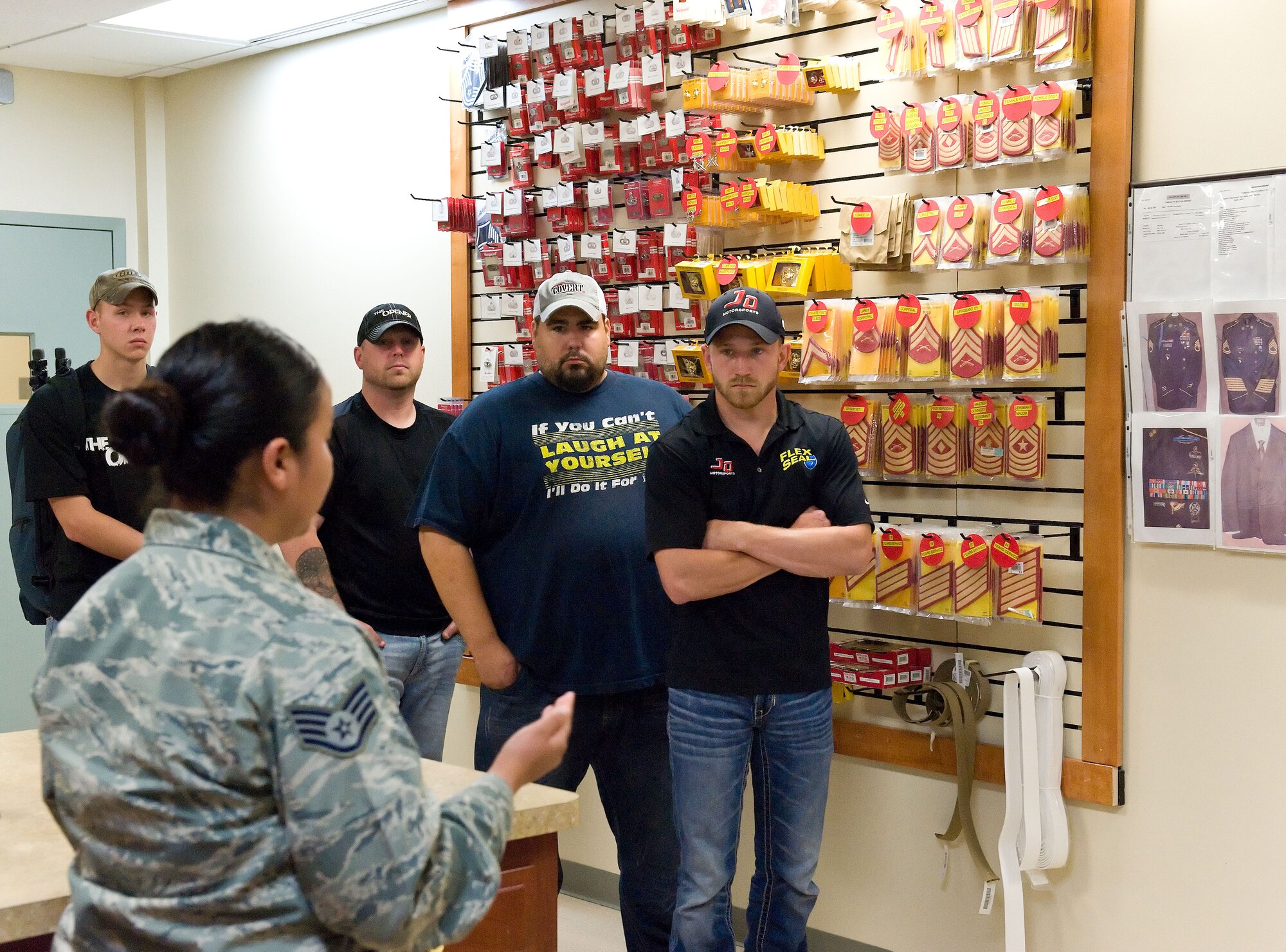 Jeffrey Earnhardt, NASCAR Nationwide Series driver of the JD Motorsports No. 4 Chevrolet Camaro, listens as Staff Sgt. Connie Martinez, uniform section NCO in charge, explains the process in preparing uniforms for fallen service members during his visit to Air Force Mortuary Affairs Operations, May 28, 2014. Earnhardt received and orientation of AFMAO and the Armed Forces Medical Examiner System as part of his visit. (U.S. Air Force photo/Roland Balik)