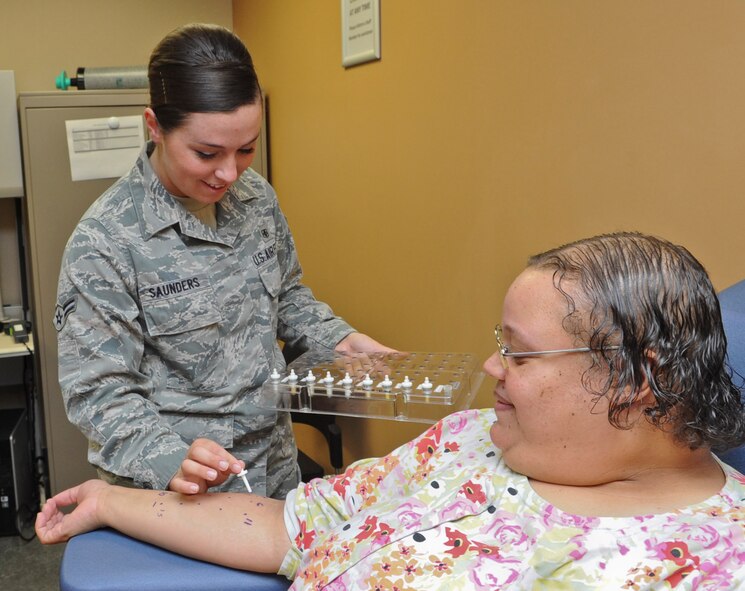 Airman 1st Class Cassandra Saunders, 56th Medical Operations Squadron allergy immunization technician, gives an allergy test to Katina Fritsch, 56th MDOS advance office clerk, May 12 at Luke Air Force Base. (U.S. Air Force photo/Airman 1st Class Cory Gossett)