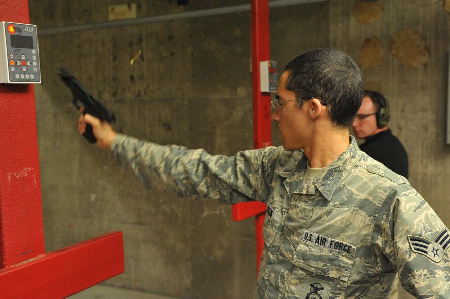 Senior Airman Michael Green, 56th Security Forces Squadron security patrolman, fires a M-9 Beretta May 14 during the shooting contest at Luke Air Force Base. Airmen, along with local members of law enforcement, participated in week-long events recognizing National Police Week. (U.S. Air Force photo/Senior Airman Jason Colbert)