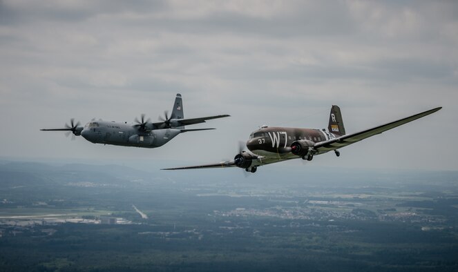 A Douglas C-47 Skytrain, known as Whiskey 7, flies alongside a C-130J Super Hercules from the 37th Airlift Squadron over Germany, May 30, 2014. The C-47 came to Ramstein for a week to participate in base activities with its legacy unit, the 37th Airlift Squadron, before returning to Normandy to recreate its role and drop paratroopers over the original drop zone in Sainte-Mere Eglise, France. (U.S. Air Force photo/Airman 1st Class Jordan Castelan)