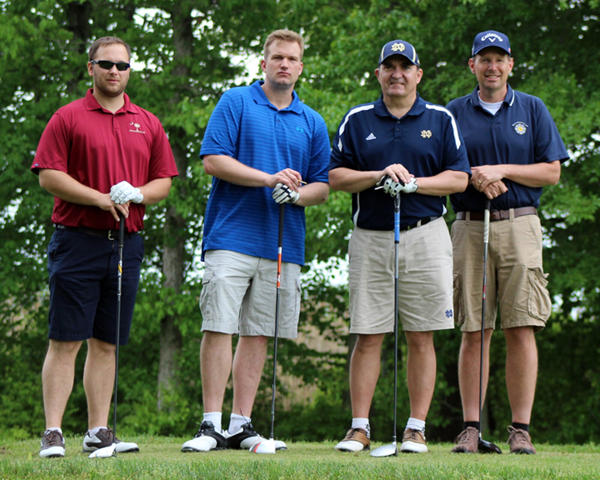 From left to right, Steve Miller, TDX Sand Point Services, Master Sgt. Spence Patton, 436th Logistics Readiness Squadron, Master Sgt. Danny Gilseth 512th LRS, and Richard Stoops Jr., George and Lynch Inc., pose for a team photo on the 6th hole of the Jonathan's Landing Golf Course in Magnolia, Del., May 15, 2014. The team shot a score of 6 under 65 during the annual Central Delaware Chamber of Commerce Bluesuiters Golf Tournament, held annually to promote the relationship between the Dover civilian community and the Dover Air Force Base community. (U.S. Air Force photo/Herbert E. Welday III)