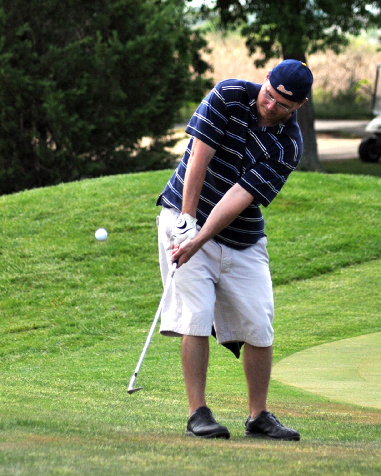Maj. Jason Pennypacker, 326th Airlift Squadron, chipped on the green during the annual Central Delaware Chamber of Commerce Bluesuiters Golf Tournament at the Jonathan's Landing Golf Course in Magnolia, Del., May 15, 2014. The event is held annually to promote the relationship between the Dover civilian community and the Dover Air Force Base community. (U.S. Air Force photo/Herbert E. Welday III)