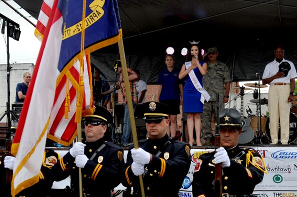 Emily Tucker, Miss Goldsboro 2014, sings the National Anthem, May 29, 2014, prior to the Center Street Jam in Goldsboro, North Carolina. This year was the 15th year of the downtown summer music concert series and was deemed Military Appreciation Jam Day in Goldsboro and Wayne County. (U.S. Air Force photo/Senior Airman Mariah Tolbert)
