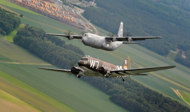 A Douglas C-47 Skytrain, known as Whiskey 7, flies alongside a C-130J Super Hercules from the 37th Airlift Squadron over Germany, May 30, 2014. The C-47 came to Ramstein for a week to participate in base activities with its legacy unit, the 37th Airlift Squadron, before returning to Normandy to recreate its role and drop paratroopers over the original drop zone in Sainte-Mere Eglise, France. (U.S. Air Force photo/Staff Sgt. Sara Keller)